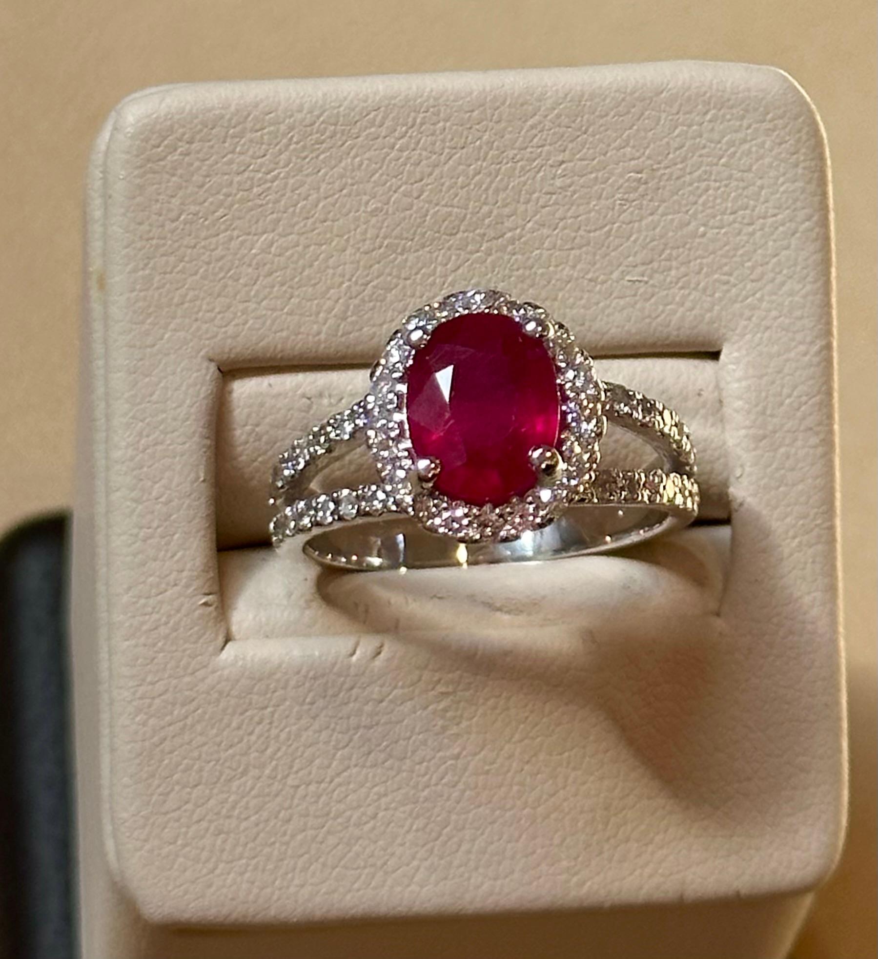Prepare to be amazed by the sheer beauty of the 2.5 Carat Oval Treated Ruby & 2 ct of Diamond Ring, a true masterpiece crafted in exquisite 14 Karat White Gold. This extraordinary ring showcases a magnificent oval cut ruby  to perfection, weighing