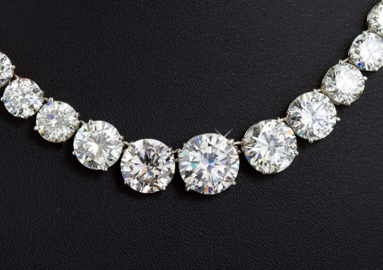 A 25 carat diamond in platinum Riviera necklace comprised of articulating links four-prong set with graduated round brilliant cut diamonds. 
