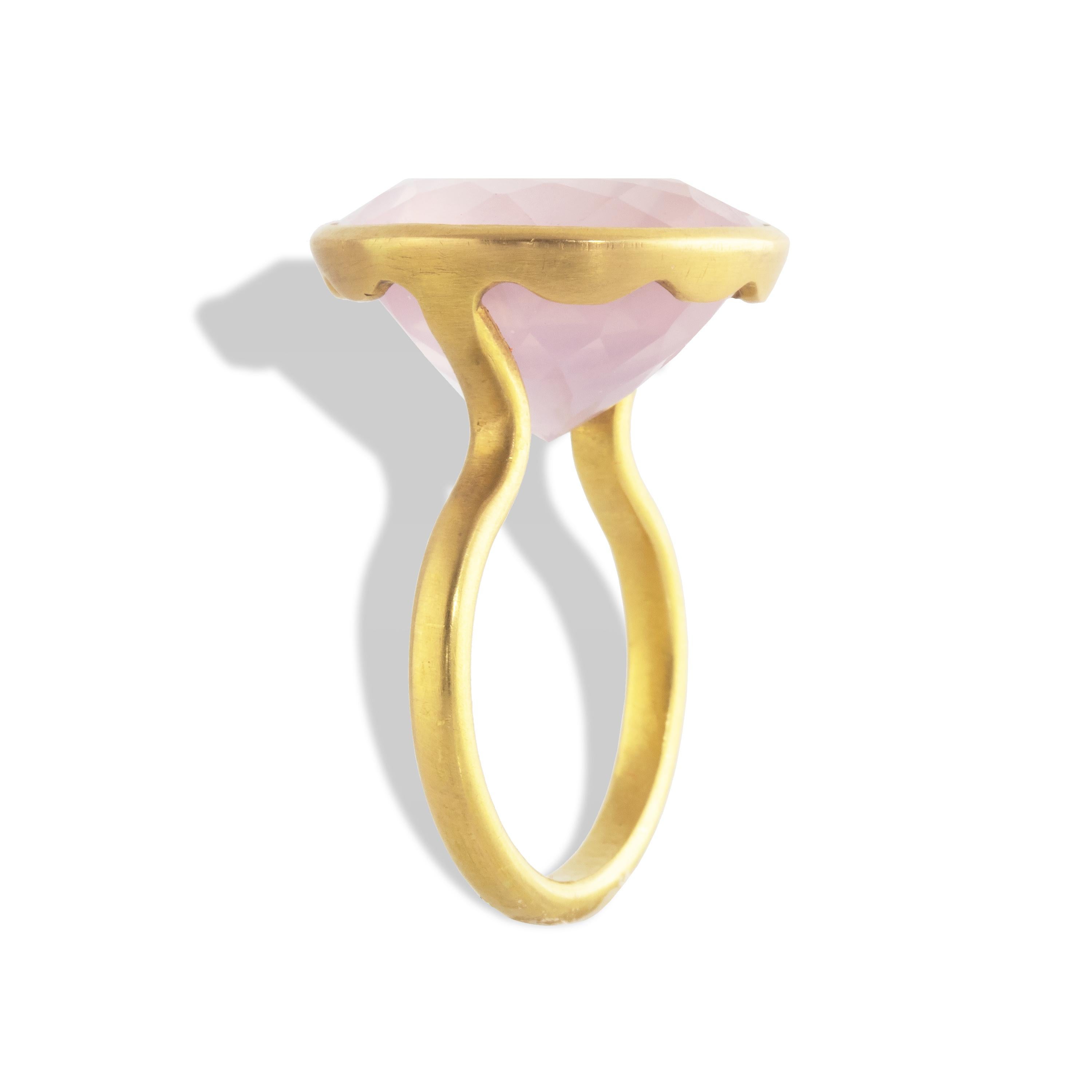 Spectacular 25 carat Rose Quartz Round Wave Ring set in 22k matte yellow gold.  

In Greek myth, Aphrodite was caught by a thorn when she rushed to help her wounded lover, Adonis. Blood from both lovers dripped onto a crystal, staining it pink as a