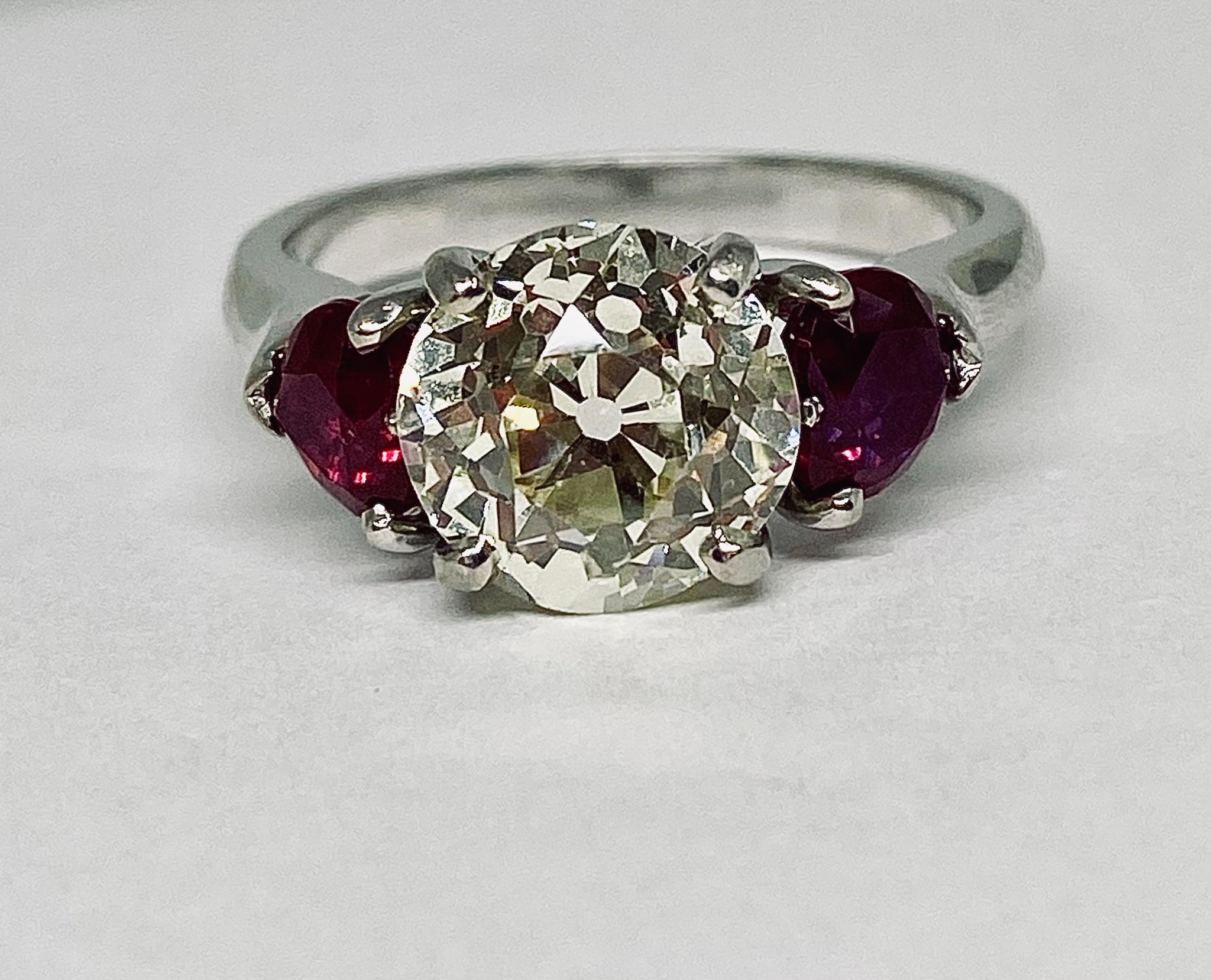 Contemporary 2.5 Carat Round Cut Diamond and Ruby Estate Three-Stone Ring in Platinum For Sale