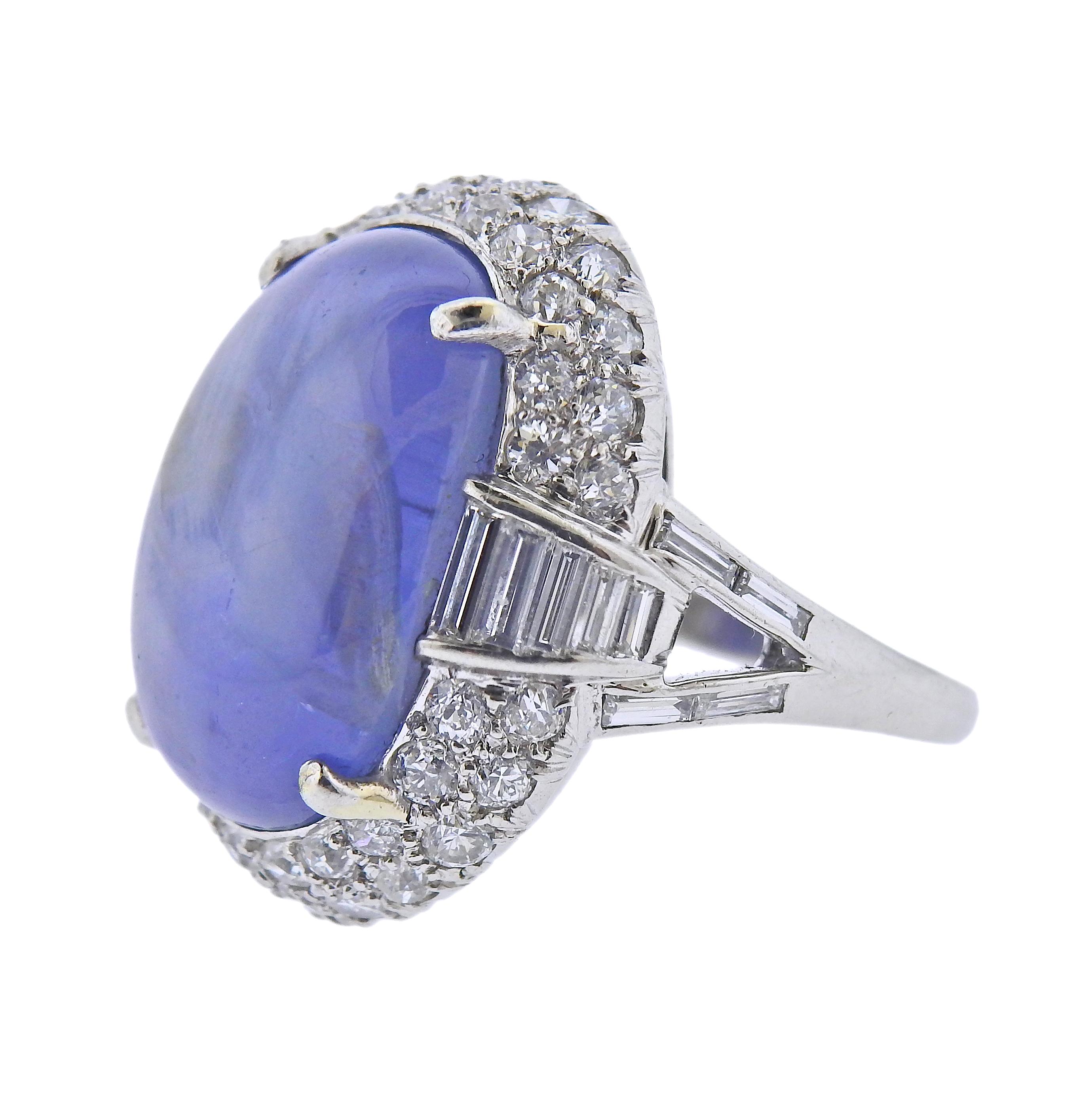 Platinum cocktail ring, featuring center 25-30cts star sapphire cabochon , measuring 20.6 x 14.7 x 9.5mm, surrounded with approx. 1.90ctw in diamonds. Ring size - 8.25, ring top - 25mm x 23mm. Weight - 20.6 grams. 
