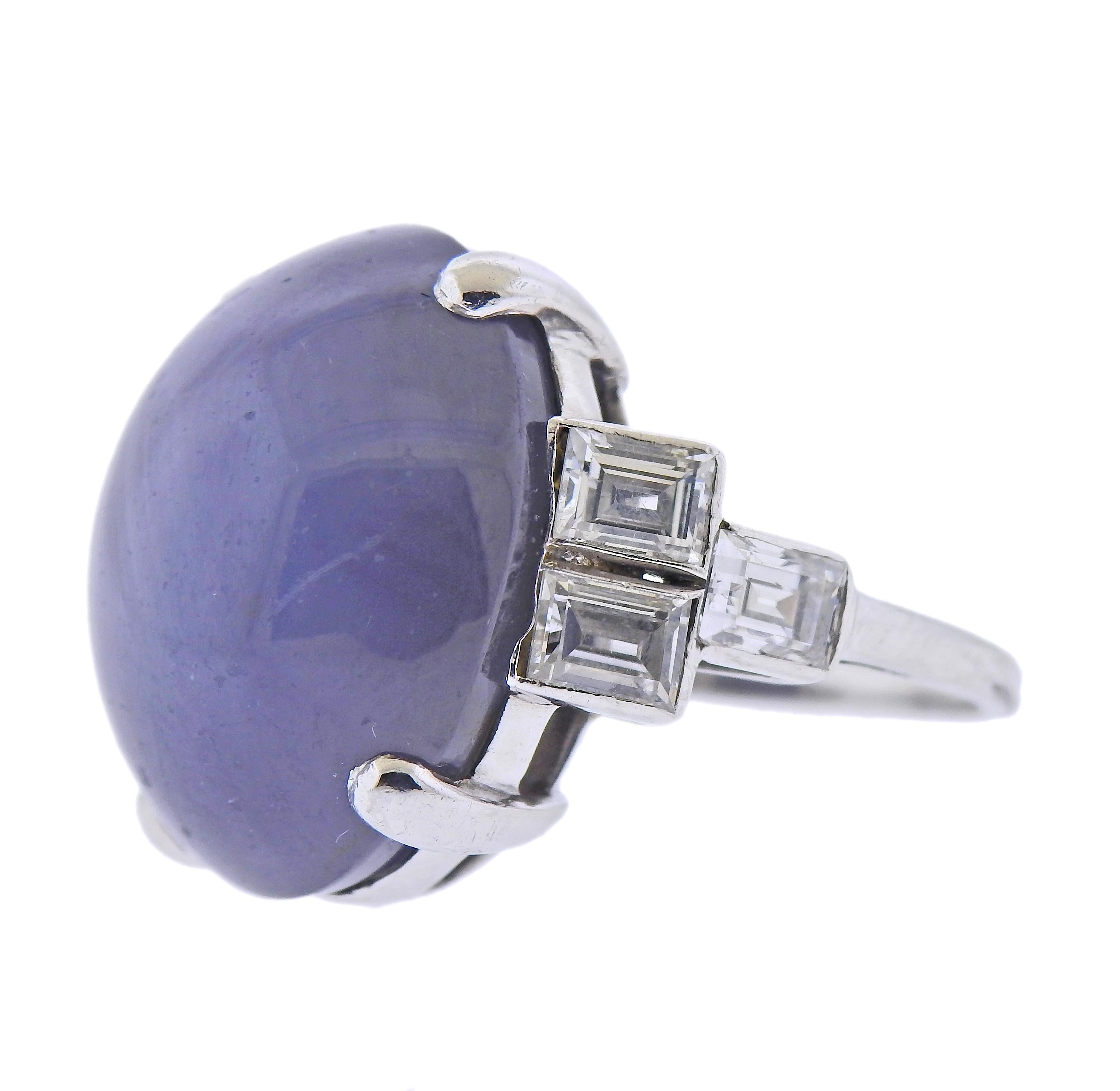 Platinum cocktail ring, with approx. 25-30ct star sapphire cabochon, surrounded with approx. 2.10ctw in diamonds (emerald cut) . Ring size - 5.75, ring top - 20mm wide. Sapphire measures 20 x 16.9 x 11.3mm (minor nicks on the top). Weight - 15.8