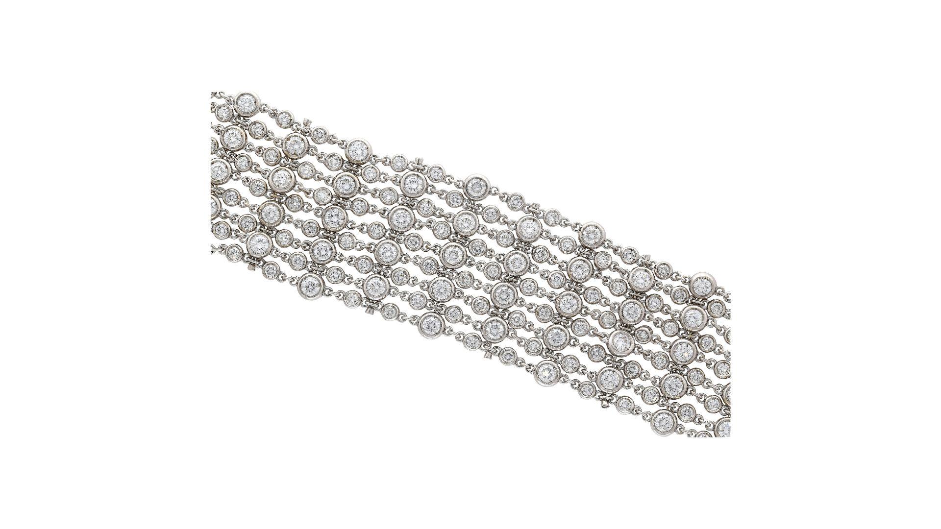 25.70 CTTW Round Cut Diamond Thick Bracelet in 18K White Gold, a luxurious piece weighing 68.40 grams and measuring 6.5 x 1.2 inches. The bracelet features 198 round-cut diamonds, each handset in a bezel setting with F-G color and VS-SI clarity. The