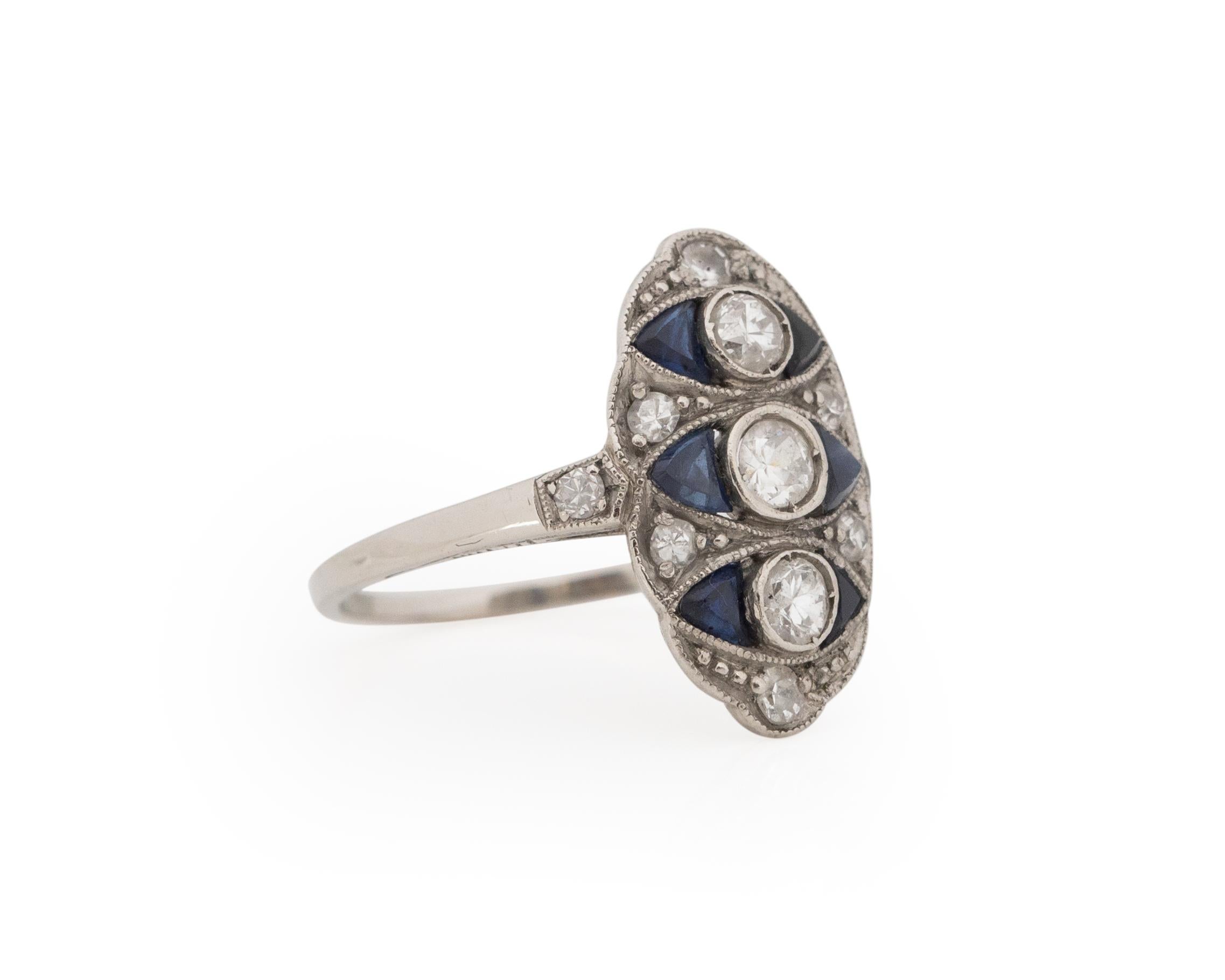Ring Size: 3
Metal Type: Platinum [Hallmarked, and Tested]
Weight: 2.0 grams

Diamond Details:
Weight: .25carat, total
Cut: Old European brilliant
Color: G-H
Clarity: SI

Side Stone Details:
Type: Sapphire, Created
Weight: .45carat, total
Color: