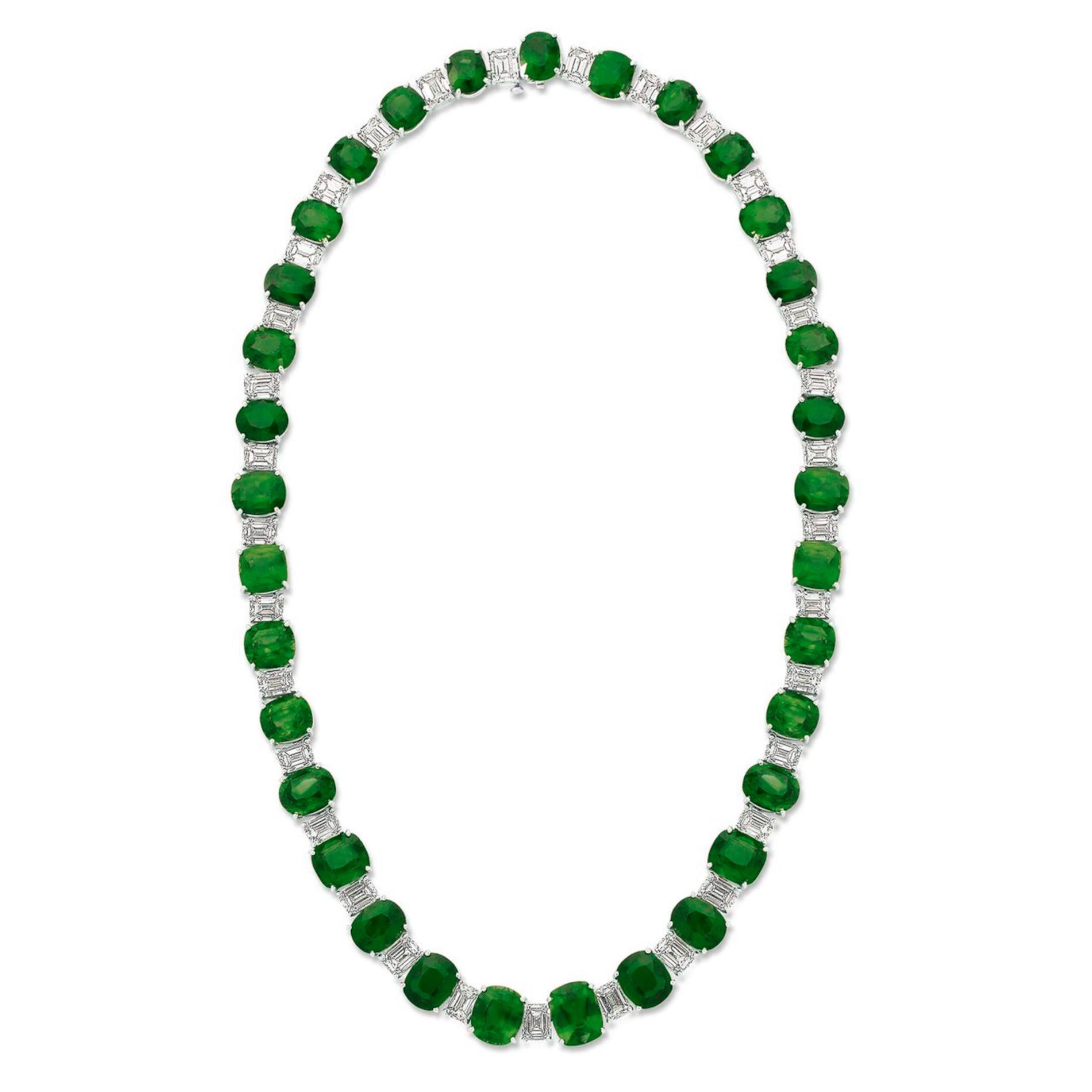 Indulge in the luxury of our Diamond and Green Emerald Necklace, a masterpiece of intricate craftsmanship and timeless elegance. This breathtaking piece is set in the cool, ethereal embrace of platinum and features 33 exquisitely cut green emeralds,