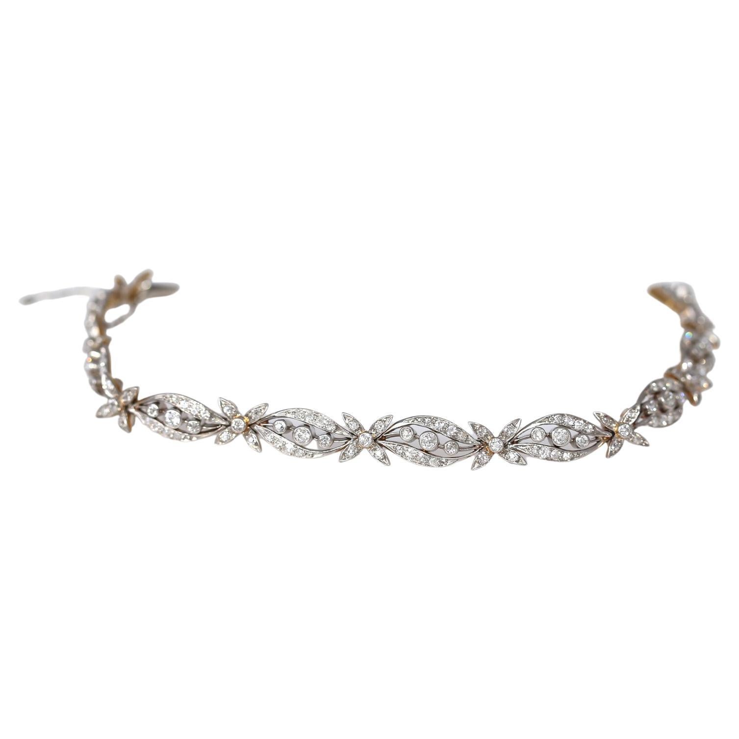 2.5 Carats Diamond Old Mine Bracelet. Created around 1930. Containing numerous old mine cut Diamonds weighing approximately 2.5 Carats in total. Mounted in Platinum-topped gold.

The floral design depicting flowers really reflects the era of the