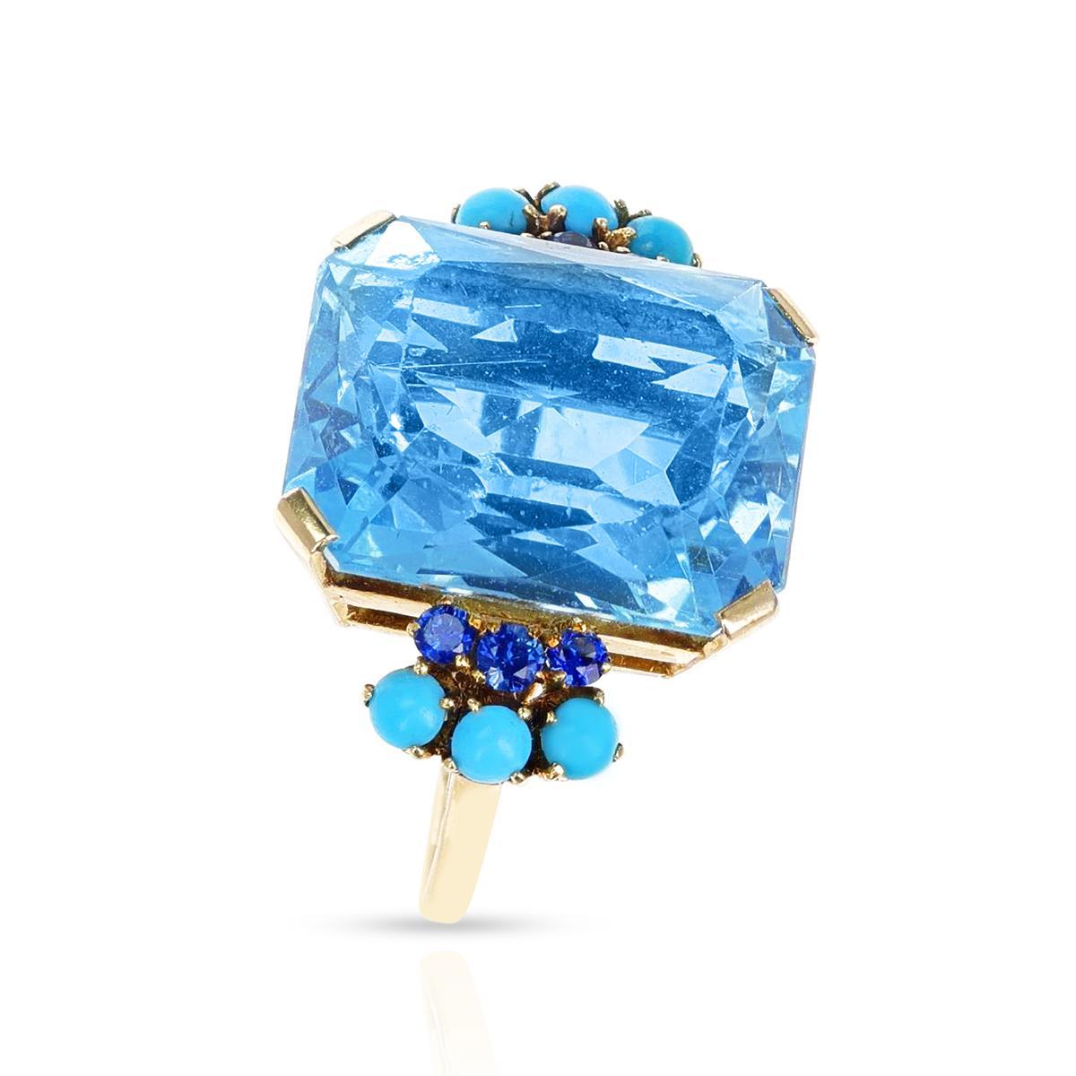 A 25 ct. Aquamarine, Sapphire and Turquoise Cocktail Ring made in 18 Karat Yellow Gold. The total weight is 13.98 grams and the ring size is US 9.