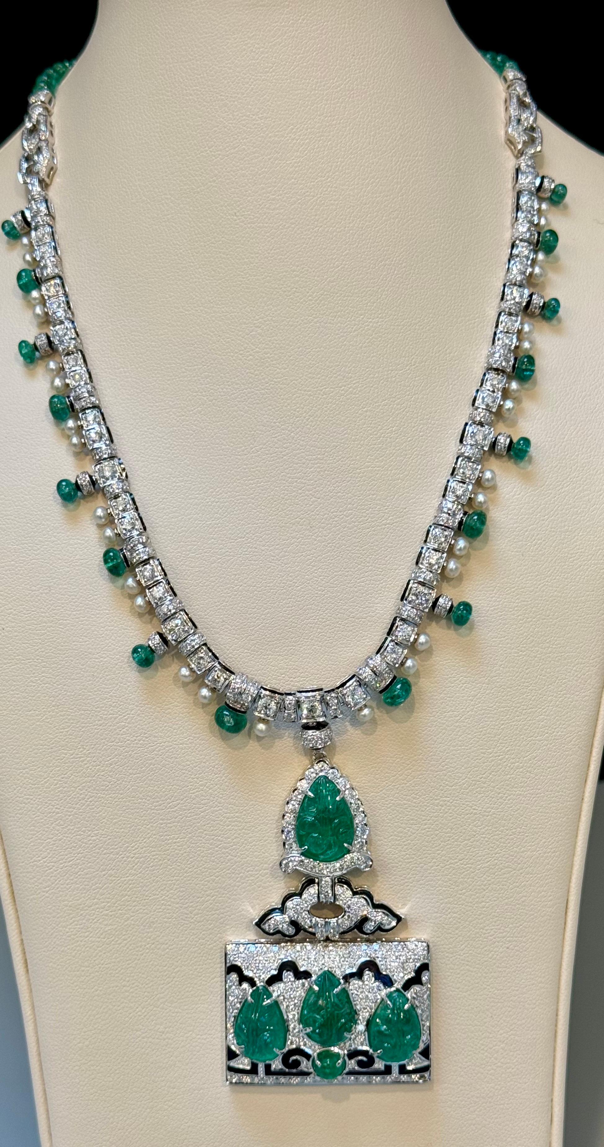 Approximately 25 Ct Natural Carved leaves Emerald & 10 Ct Diamond Art Deco 18 Karat White Gold Necklace with Emerald Beads
This exquisite necklace boasts a harmonious blend of natural carved emeralds, weighing around 25 carats, and dazzling diamonds