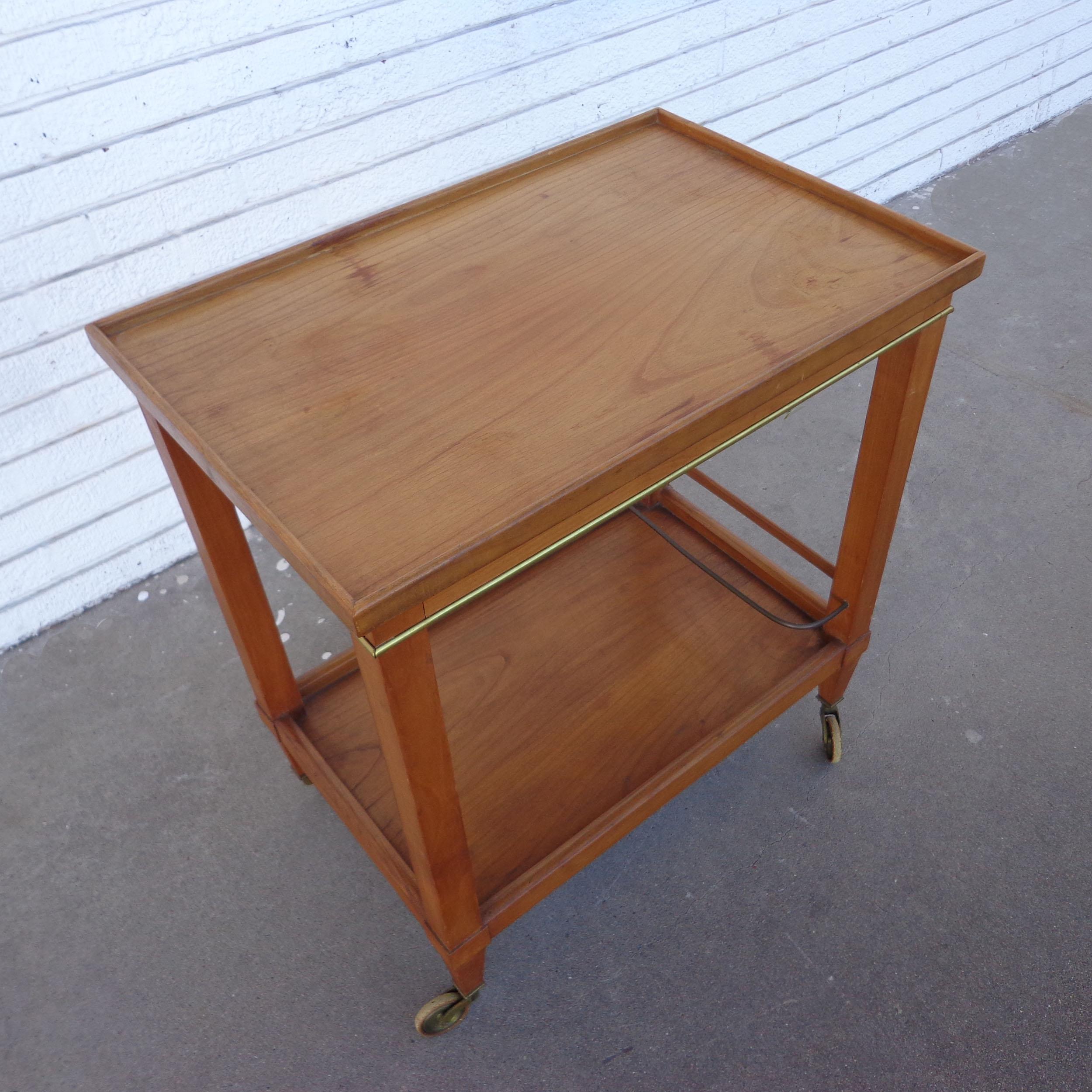 Mid century teak bar cart

Two tier cart In teak with brass trim. Castors. Section for bottles or glassware on bottom shelf.

Measures: 25.25 Width x 16.25 Depth x 28 Height.


  