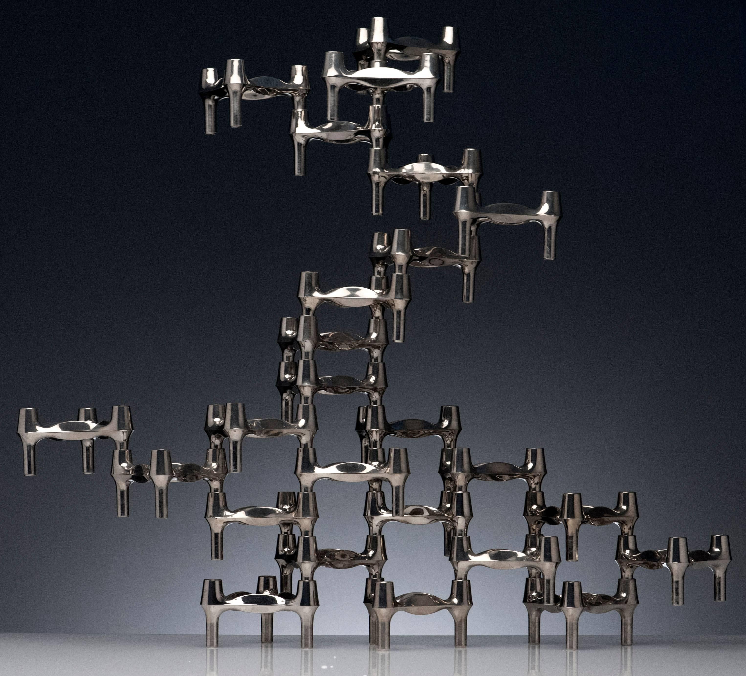 25 Nagel candleholders manufactured by BMF of Germany. Clever inter-locking and stacking design allows for endless configurations. The sculptural quality makes it a great centrepiece. Quality made of solid chromed nickel. Condition is excellent.