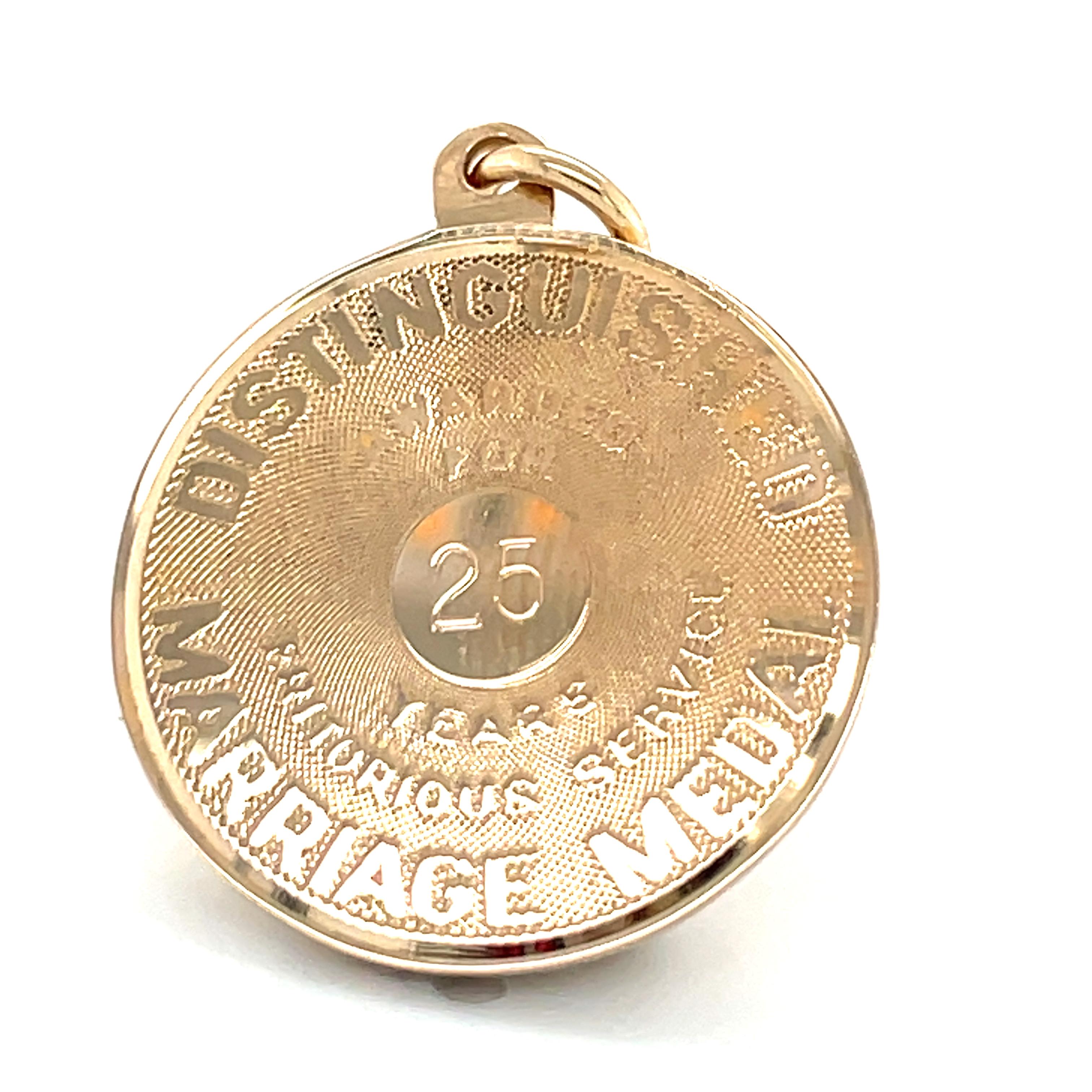 Amusing charm:  a round gold disc with applied letters:  