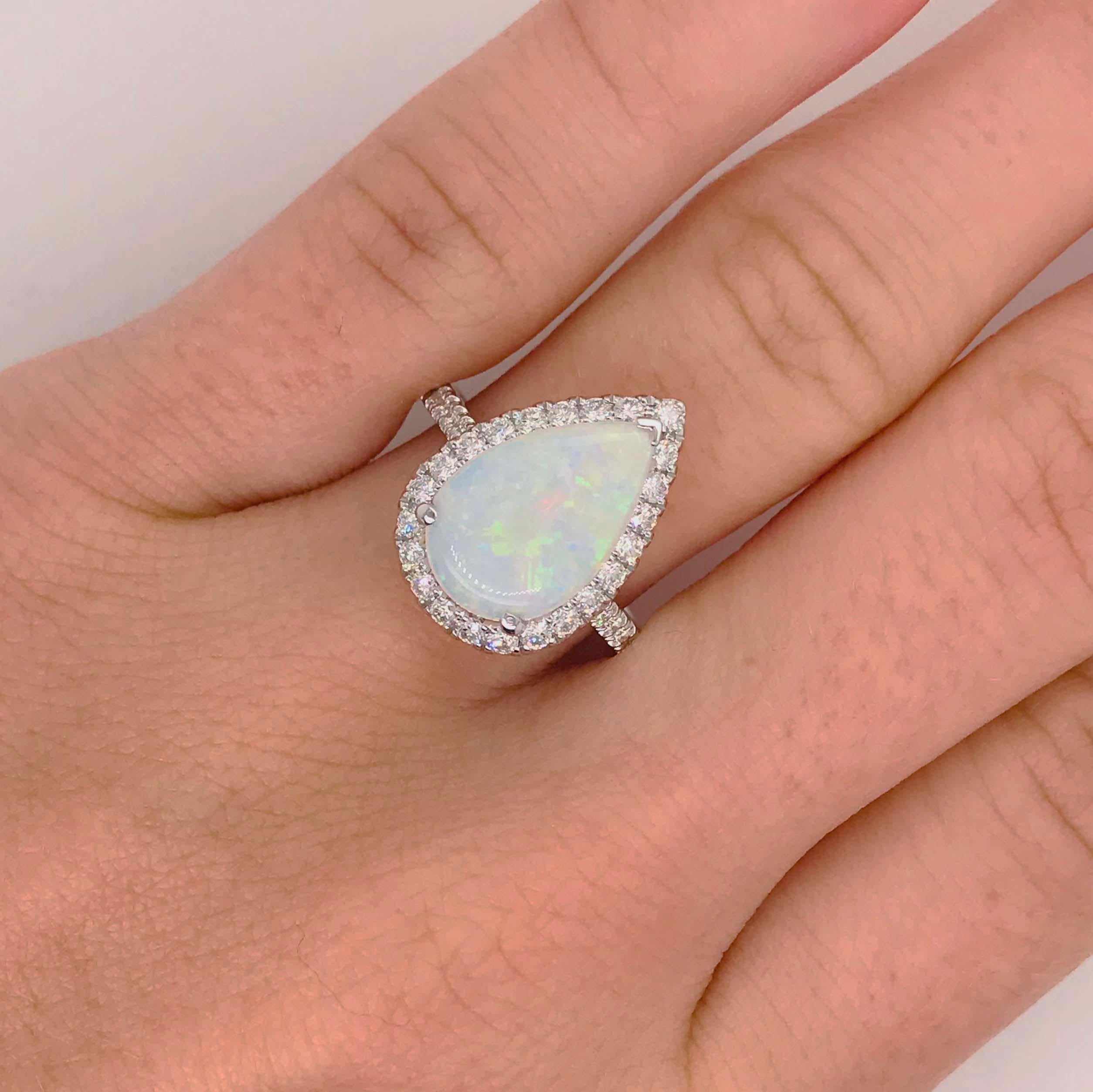 Stunning Australian opal set in a unique designer setting! This bold ring has a pear shaped Australian opal gemstone set in three prongs with one 