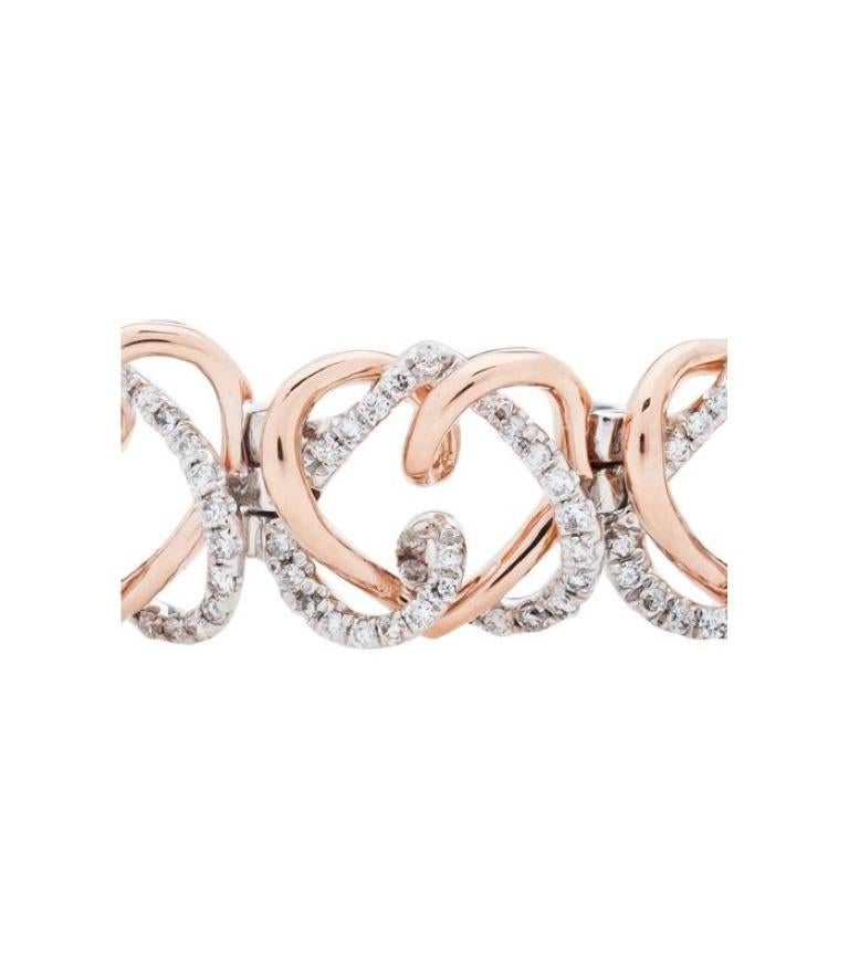 Intertwined double heart links make up this exclusive, super romantic, 18 Karat White and Rose Gold Bracelet. Genuine Round Brilliant Cut Diamonds are grain set in each 18 Karat heart and total 2.50 Carats. Each 18 Karat White Gold Diamond heart is