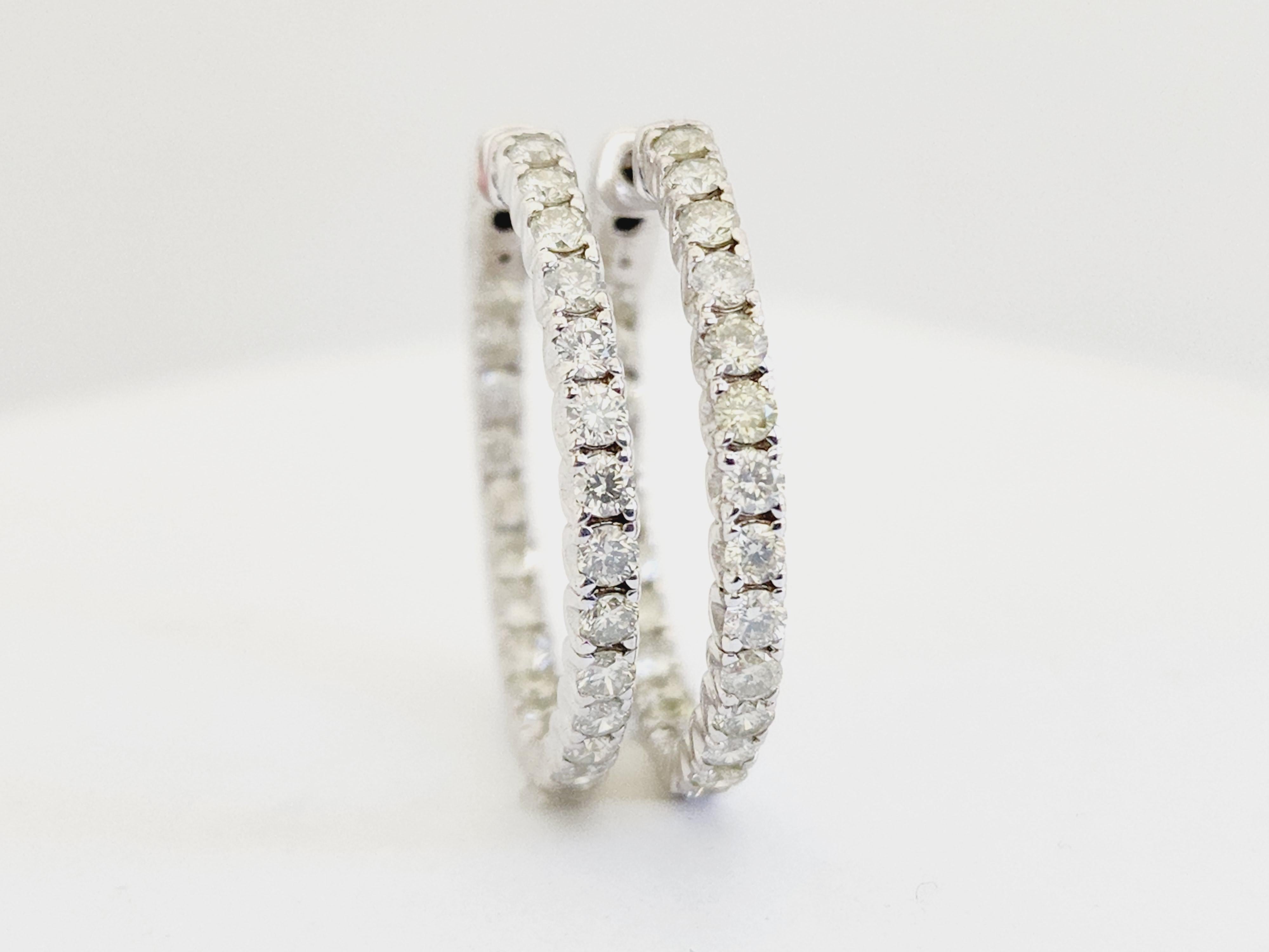 Beautiful pair of natural diamond inside out hoop earrings in 14K white gold. Secures with snap closure for wear. 
Average Color I, Clarity SI, Measures 1 inch diameter. 