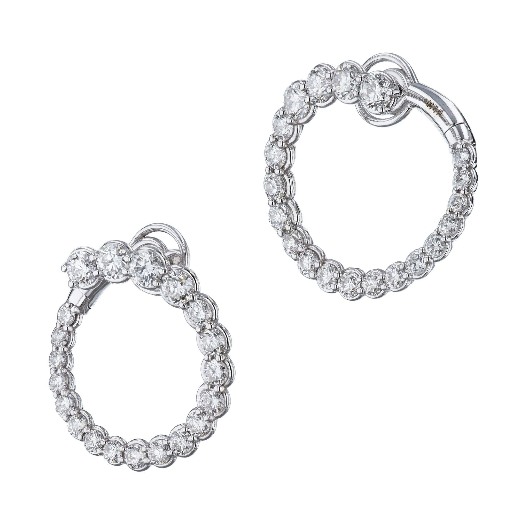 These beautiful 18 karat white gold earrings sparkle and dazzle with diamonds! 
Make a statement and treat yourself to these beautiful and luxurious earrings. 
There is a total of 2.50 carats of F colored diamonds with VS2/SI1 clarity. 
These