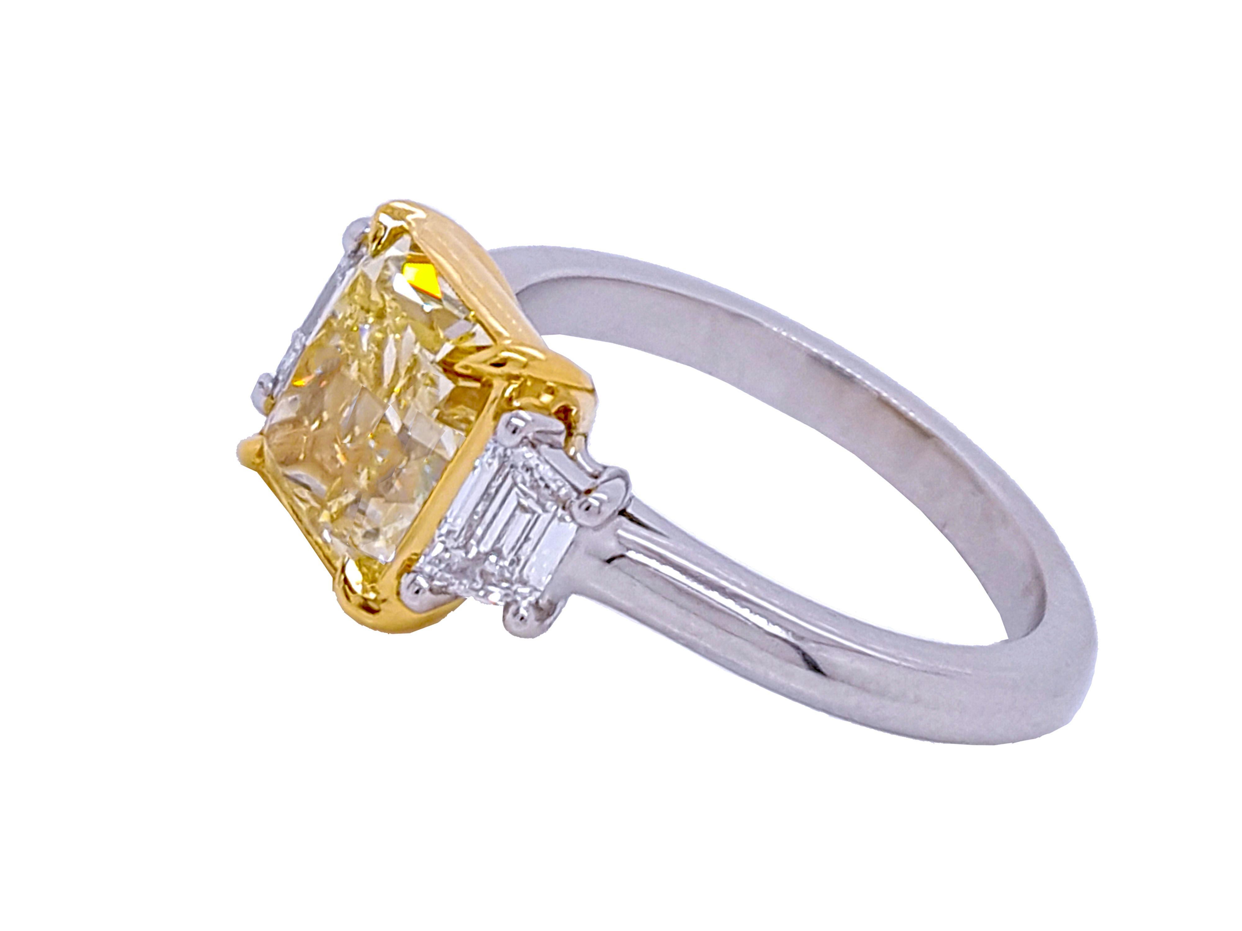 Absolutely stunning engagement ring style showcasing a Fancy Yellow 2.56 carat rectangular cut diamond certified by GIA as VS2 clarity. Flanked by two Trapezoid cut diamonds total weight 0.48 carat. VVS1.

This piece was handmade at the Novel