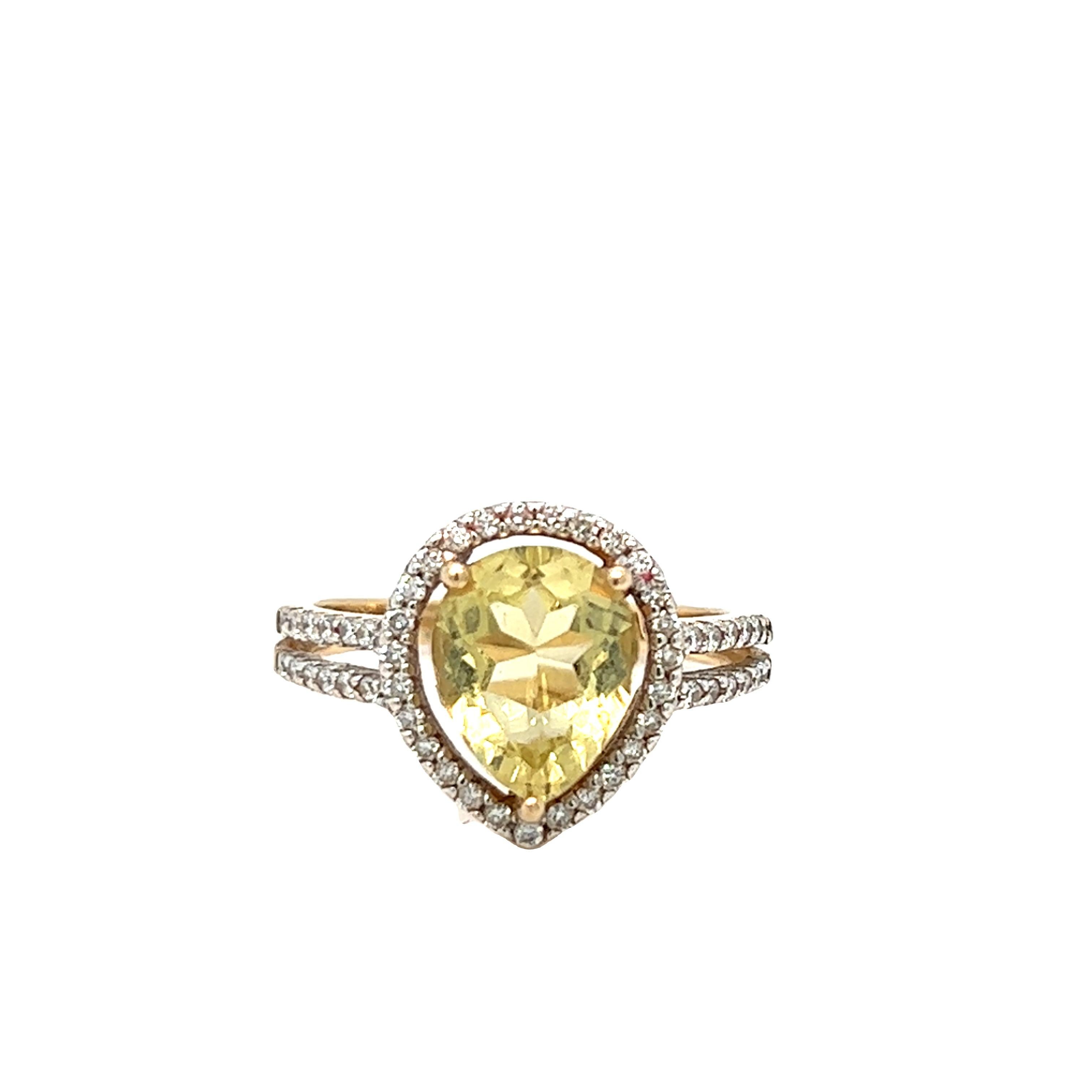 This beautiful pear-shaped golden yellow beryl is encircled in round brilliant diamond cut halo. The split shanks add a modern touch to the ring. The yellow beryl center stone weighs approximately 2.50 carats and measures 10.6 x 7.7 x 5 mm. The