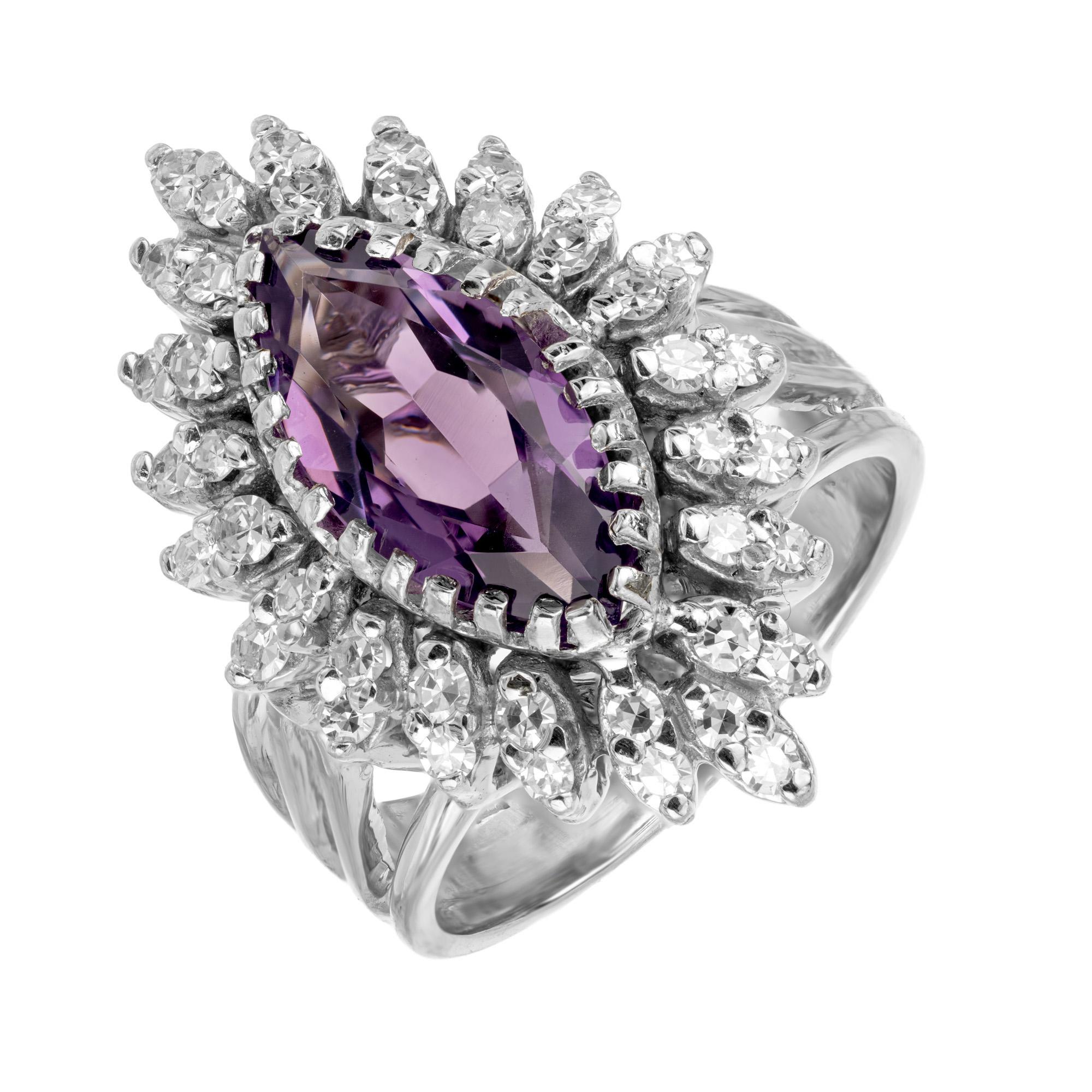 Mid-Century 1950s Marquise amethyst diamond halo cocktail ring. The amethyst is 2.50cts with a rich, deep purple. The gemstone is enriched by a halo of 40 single cut white diamonds in a two row arrangement. The mounting is a 14k white gold split