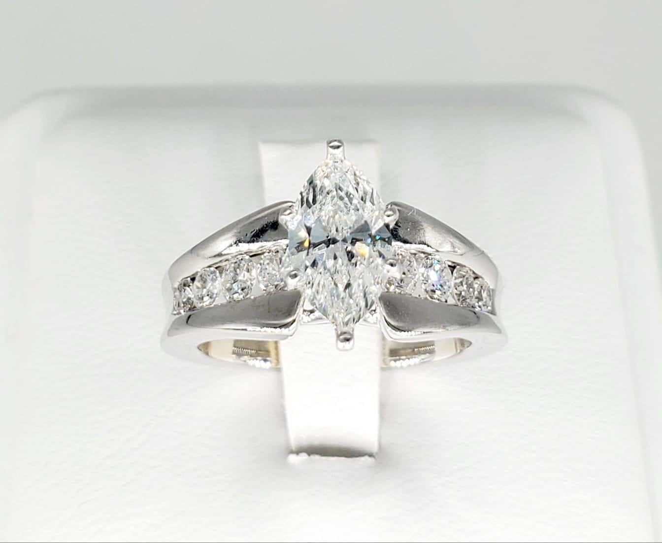 2.50 Carat Marquise VS1/G Engagement Ring. The center marquise diamond weights approx 1.20 carat and surrounded by approx 1.30 carats of round diamonds. The ring is made of 14k solid white gold and weights 8.4 grams.
The diamond is verified with a