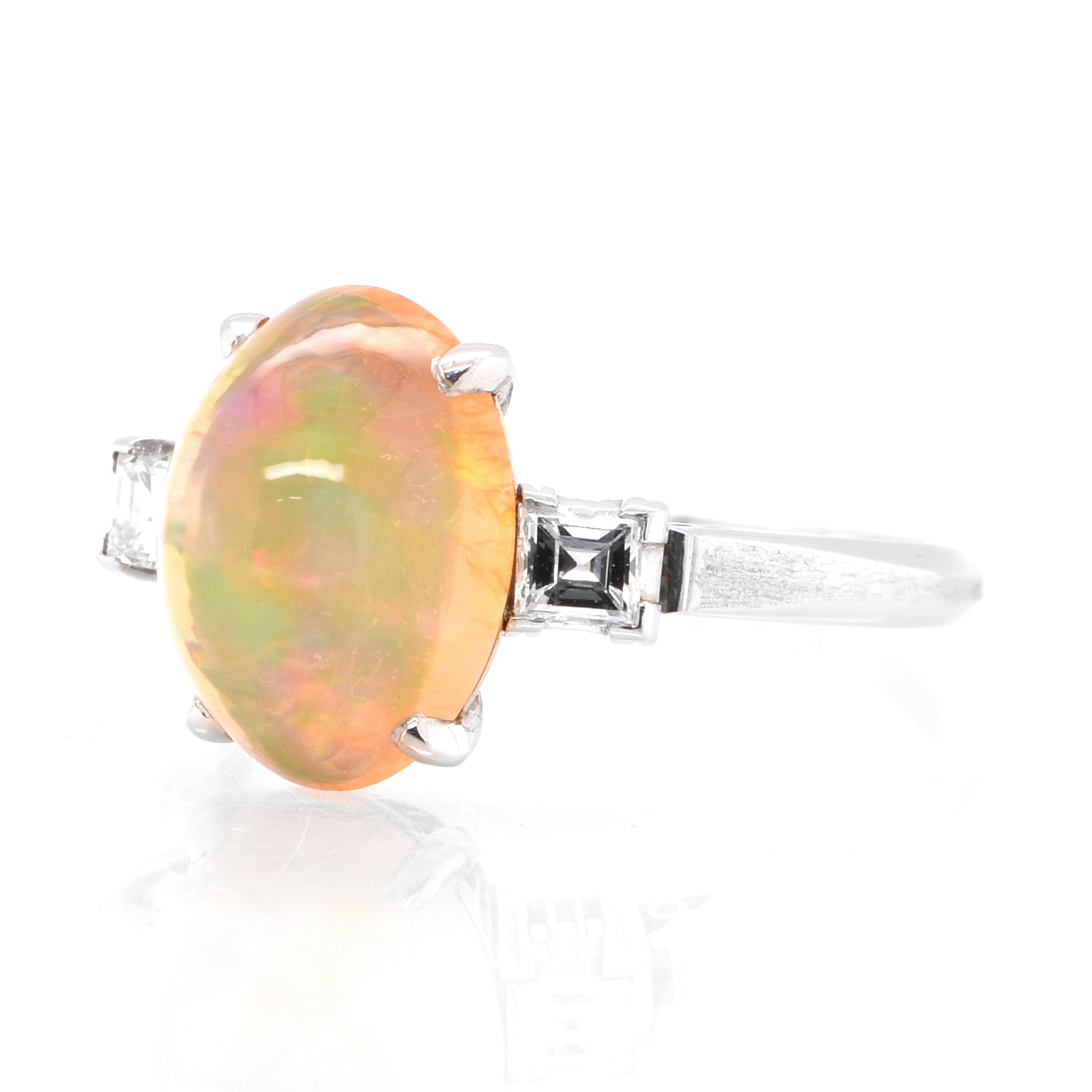 A beautiful ring featuring a 2.50 Carat Natural Mexican Fire Opal with very good play of color and 0.20 Carats of Diamond Accents set in Platinum. Opals are known for exhibiting flashes of rainbow colors known as 
