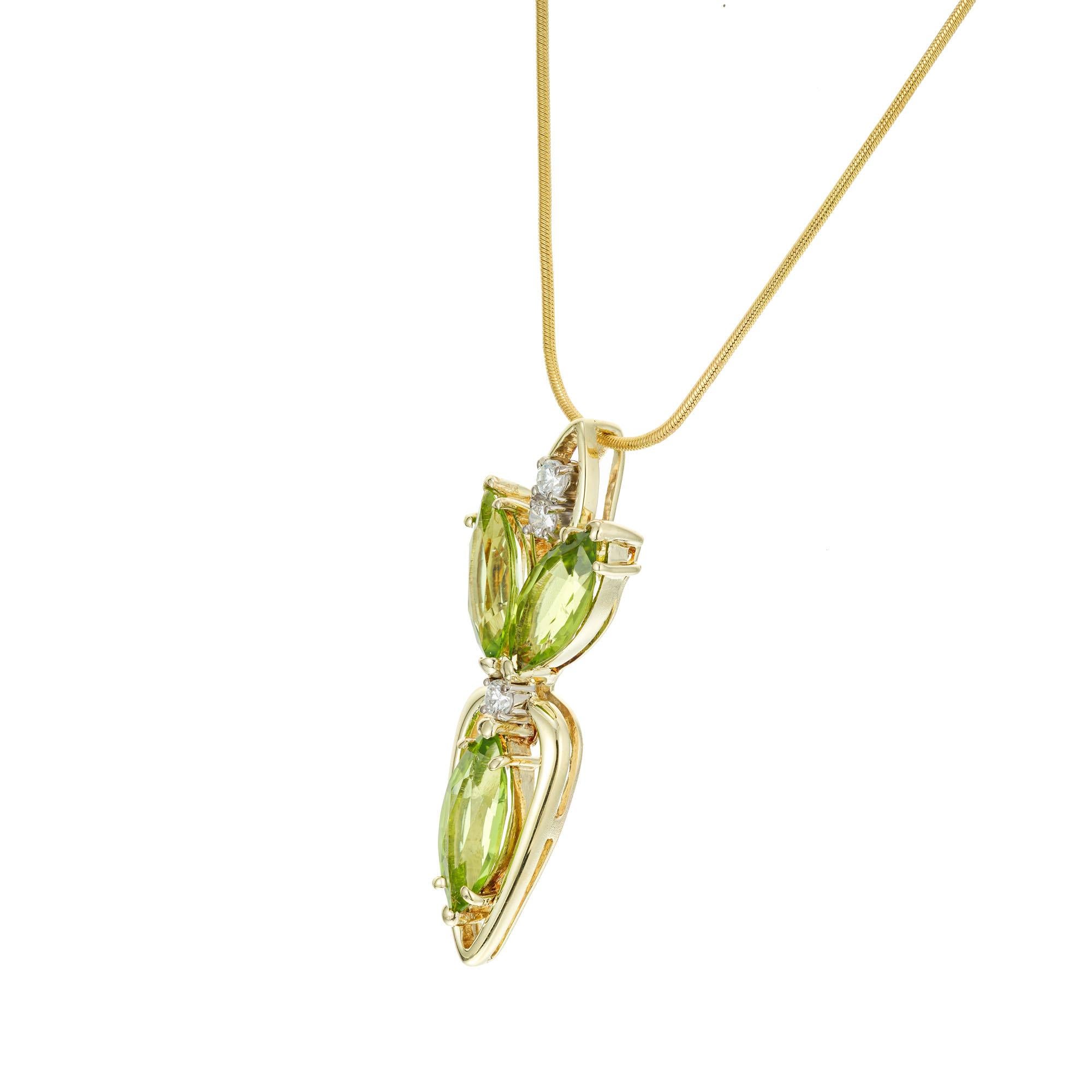 Peridot and diamond pendant necklace. 3 marquise shaped peridots accented with 3 round diamonds in 14k yellow gold. 18 inch snake chain with a lobster catch.

3 marquise yellowish green peridot, VS-SI approx. 2.50cts
3 round brilliant cut diamonds,