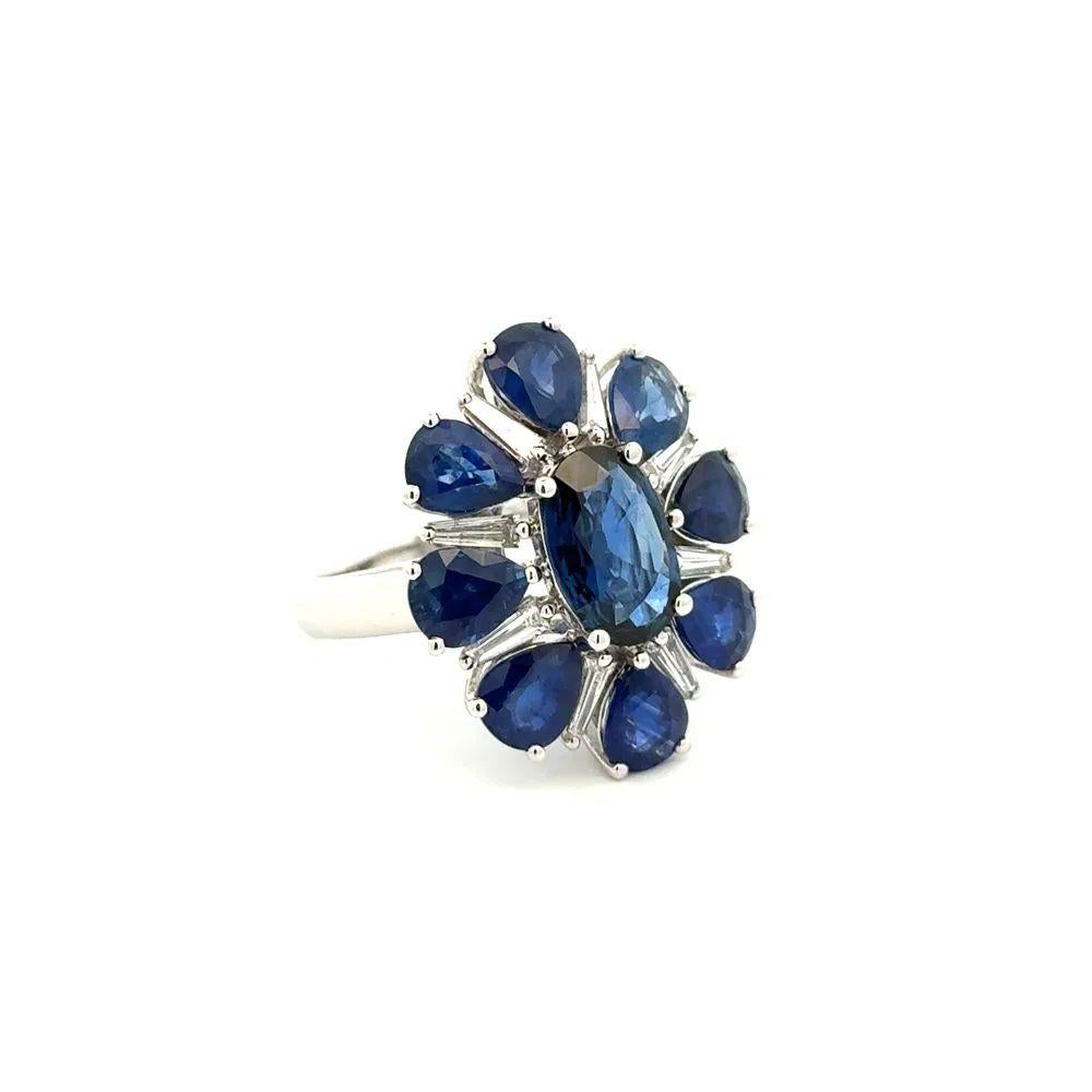 Simply Beautiful! Finely detailed Vintage Blue Sapphire and Diamond Gold Statement Cocktail Ring. Centering a securely nestled Hand set 2.50 Carat Oval Sapphire. Exquisitely surrounded by 6.00tcw Pear Sapphires and 0.68 Baguette Diamonds. Hand