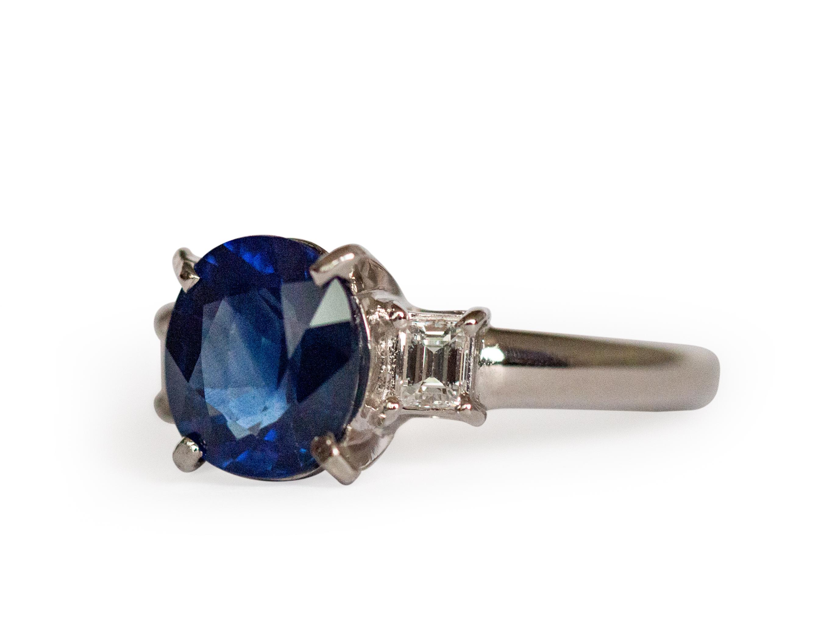 Ring Size: 6
Metal Type: Platinum  [Hallmarked, and Tested]
Weight:  5  grams

Center Sapphire Details:
Weight: 2.50 carat
Cut: Oval Brilliant
Color: Blue
Clarity: VS
Heated

Side Diamond Details:
Weight: .50 carat, total weight
Cut: Carre