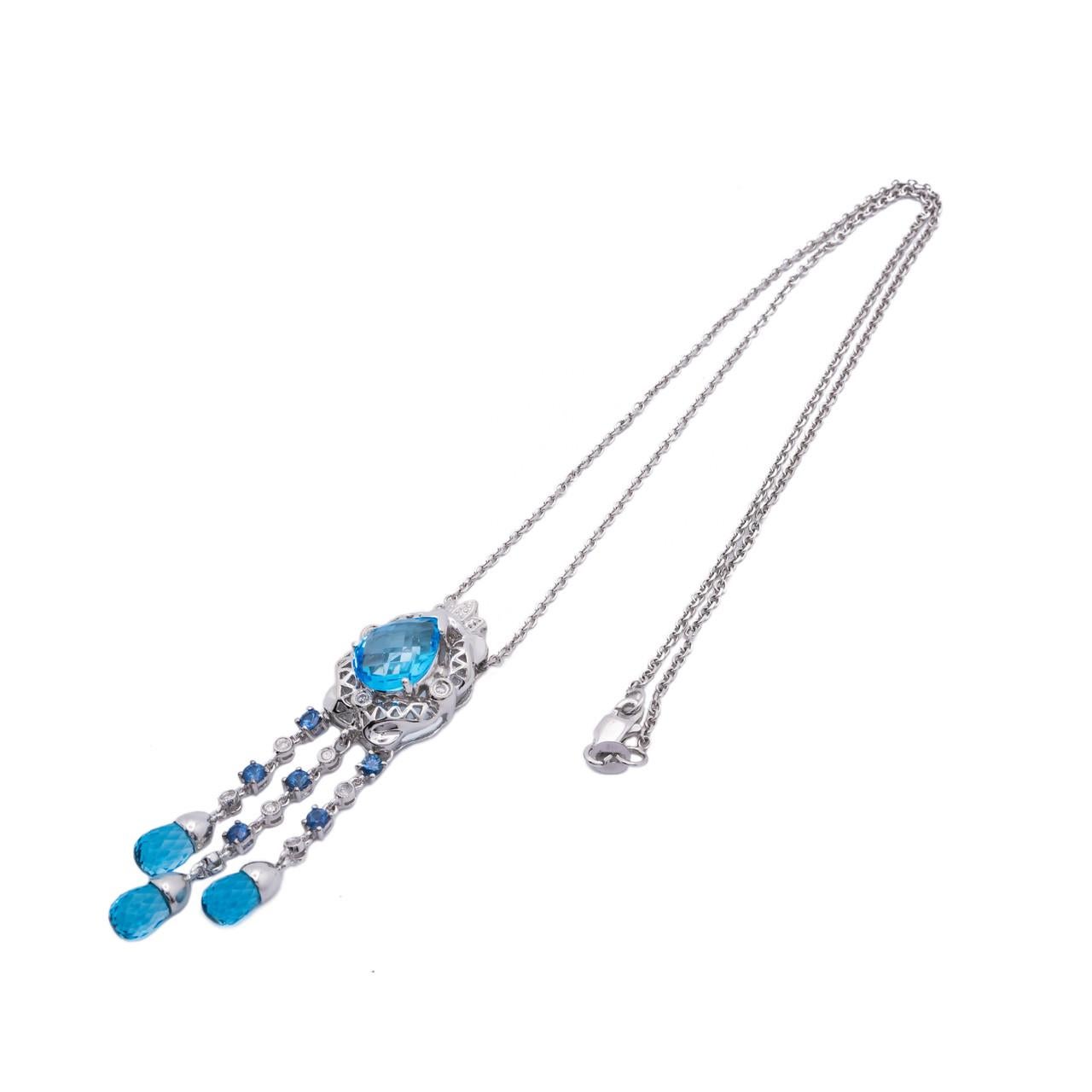 Dramatic 14k white gold drop pendant necklace with bright blue topaz, sapphire and diamond accents circa 2000's.

1 pear shaped blue topaz, approx. 2.50cts
3 blue topaz briolette's, approx. 1.50cts
10 round brilliant cut diamonds, I-J I approx.