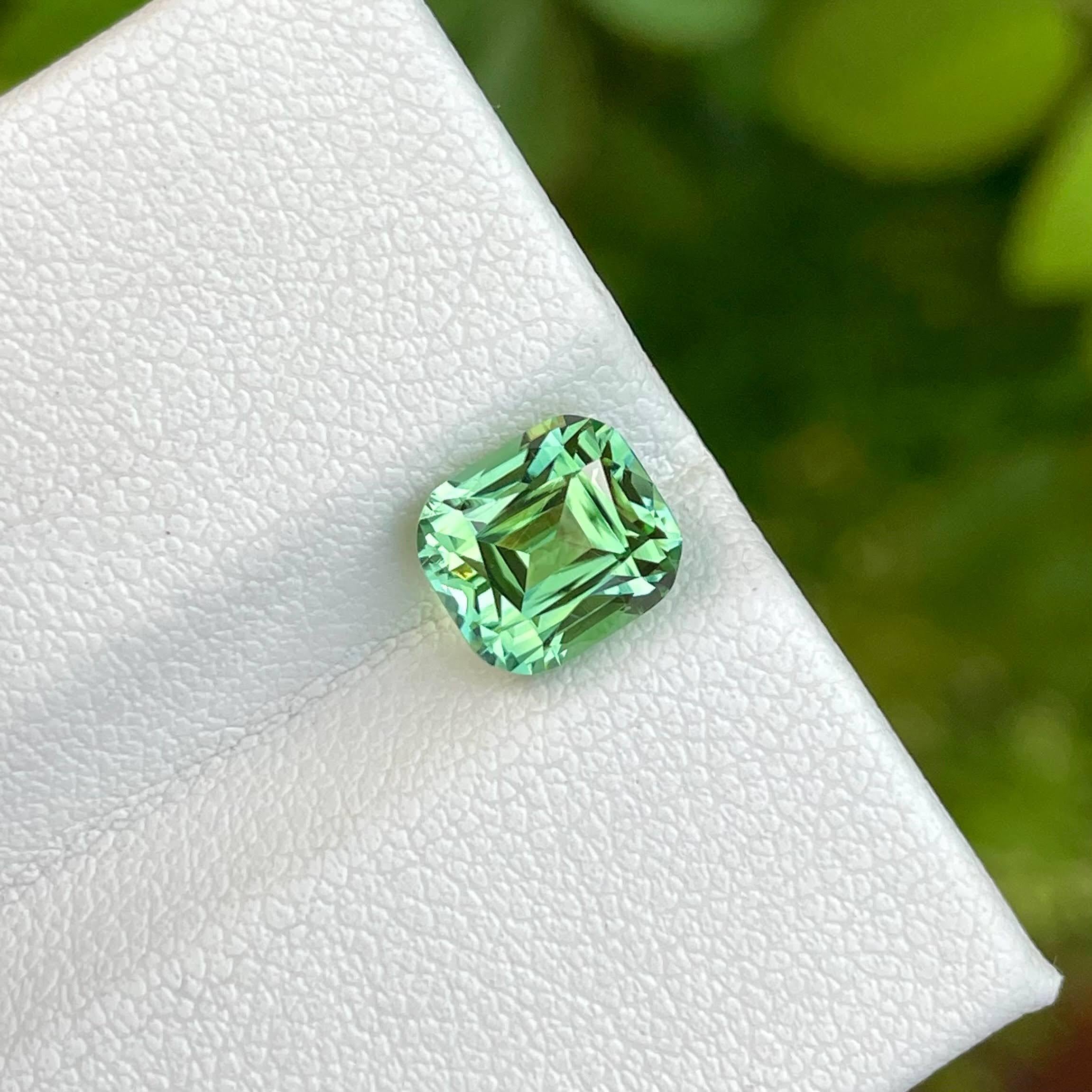 The 2.50 carat Mint Green Tourmaline stone, meticulously cut into a cushion shape, is a striking example of Afghanistani gemstone craftsmanship. This gemstone radiates a refreshing and vivid mint green hue, reminiscent of lush spring foliage, which