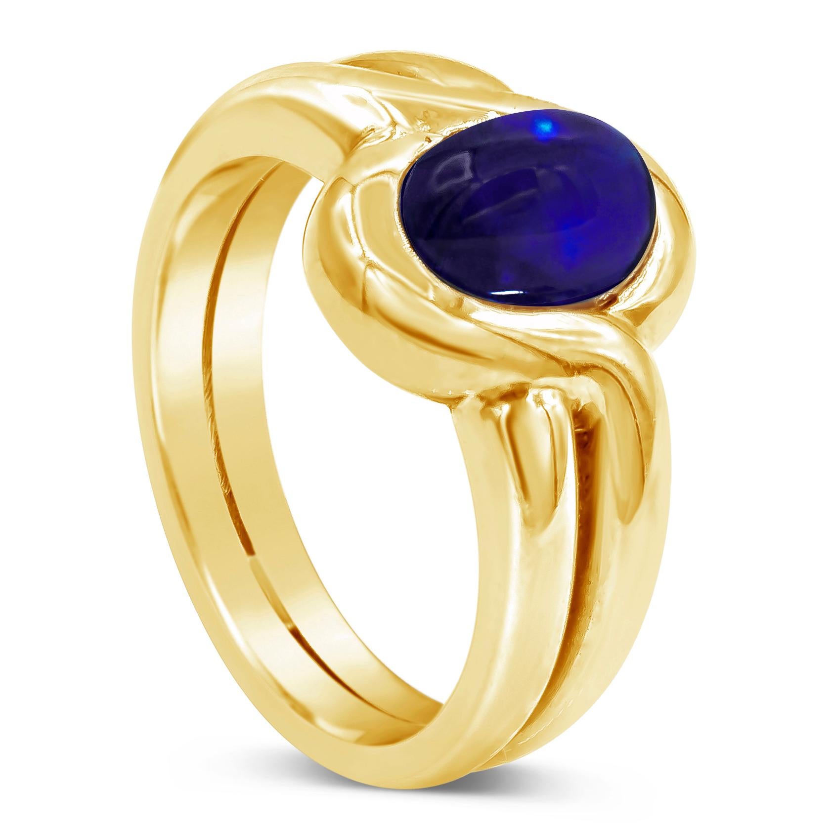 Antique gemstone fashion ring showcasing a 2.50 carat oval shape blue sapphire cabochon in the center. Set in an integrated bezel, made in 18K Yellow Gold. Size 8 US and resizable upon request. 
