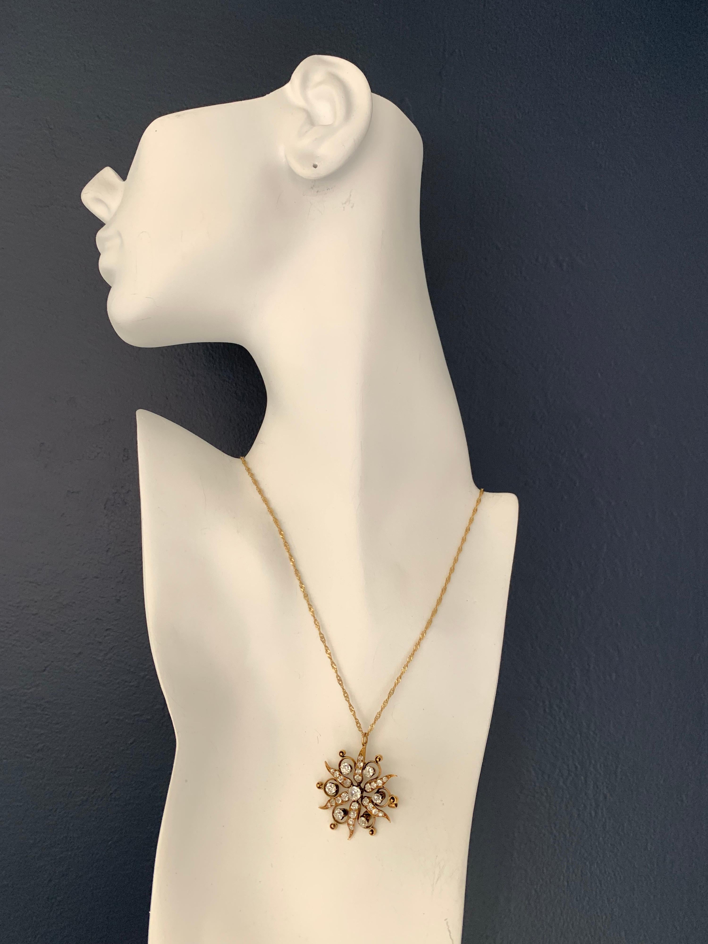 A stunning original gold pendant, set with 31 natural Old European Cut diamonds approximately H-I color and SI clarity. Weight is 7.06 grams without chain, 9.2 grams with chain. The 16