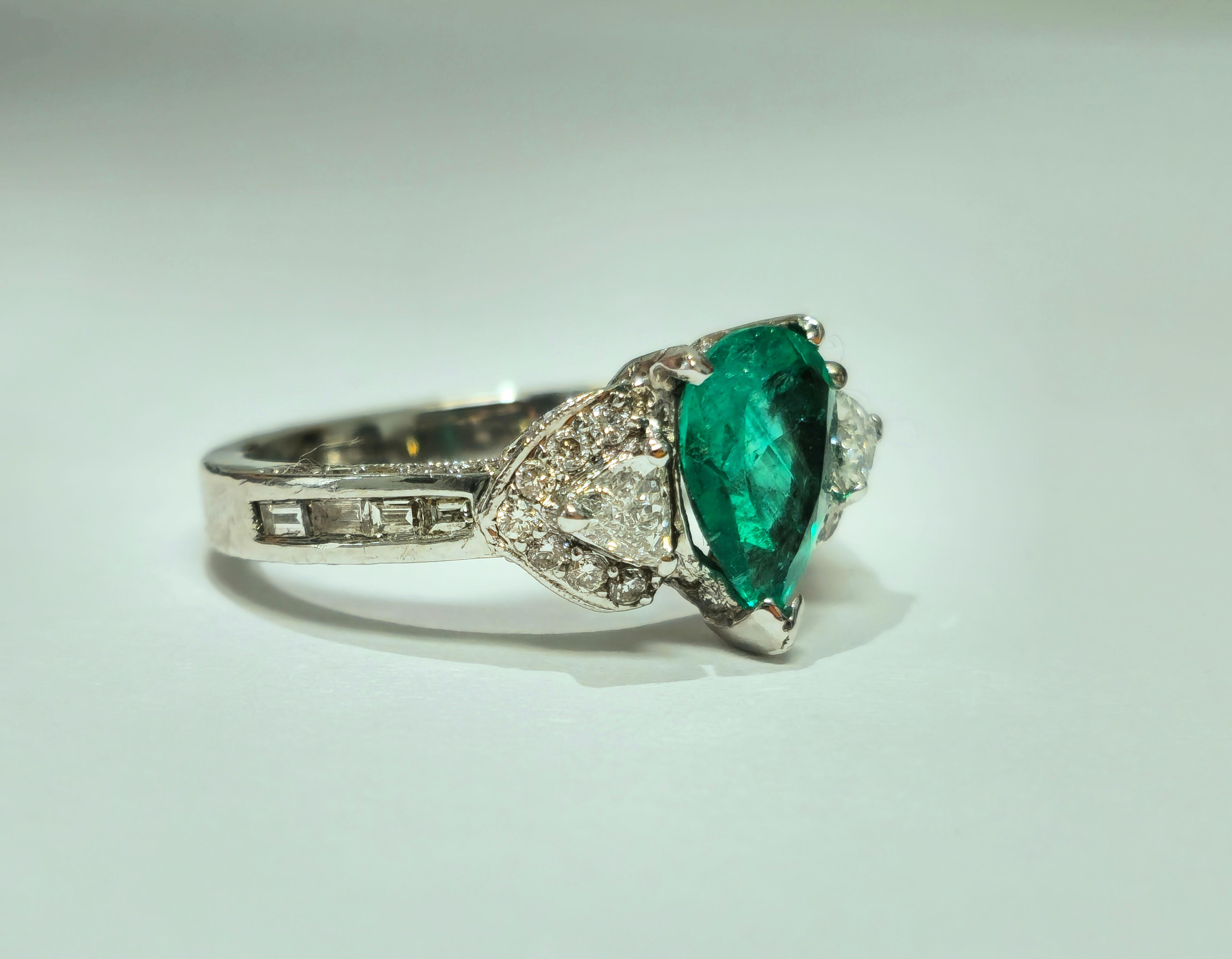Intricately crafted in 18K white gold, this exquisite vintage ring features a stunning 2.50 carat Colombian pear-shaped emerald, exuding natural elegance. Accentuating its allure are 1.00 carat trillion-cut diamonds, adding a touch of sophistication