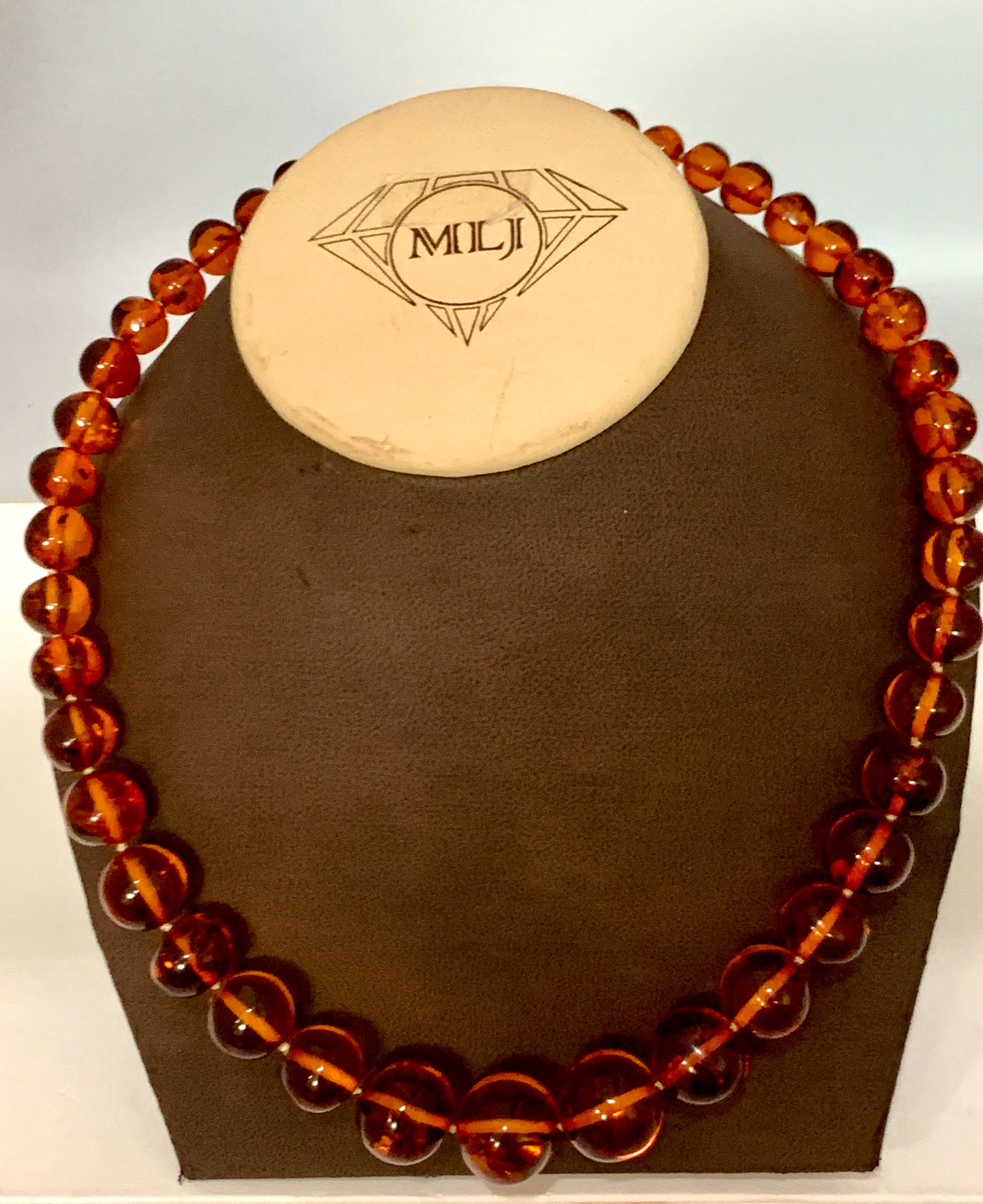 Approximately 250 Ct Natural Amber Single Strand Graduating Bead Necklace with 14K Gold  Clasp
Single  layers of Natural Amber  Beads
Beautiful intense color 
42 Beads total 
Biggest Bead is 20 MM and smallest is 8 MM
Length of the necklace is 20