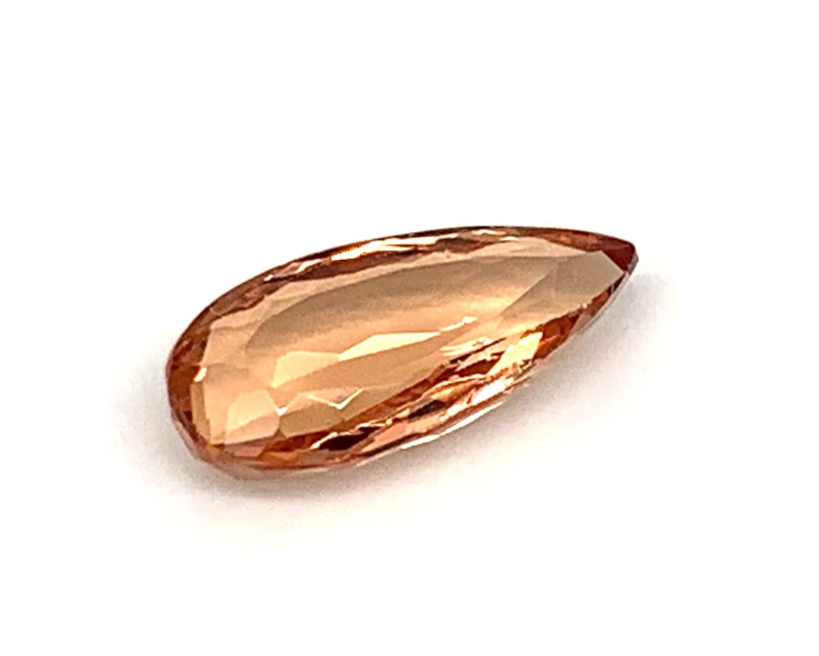 This elongated pear shaped precious topaz is also known as Imperial topaz, recognized for its luscious peach color. Precious topazes are sometimes faceted in such a way that they appears larger than their weight would suggest, while still displaying