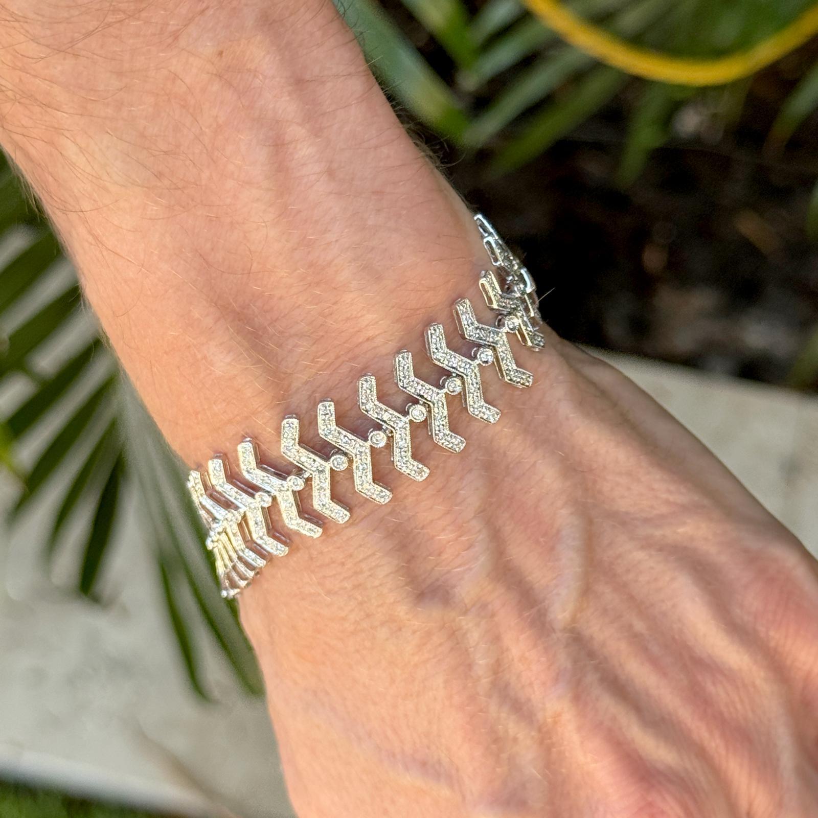 D'une élégance saisissante, ce bracelet en or blanc 14 carats présente un maillage audacieux en forme d'arête de poisson, serti d'environ 240 diamants ronds de taille brillant totalisant 2,50 carats (couleur H-I et pureté SI). Les diamants sont