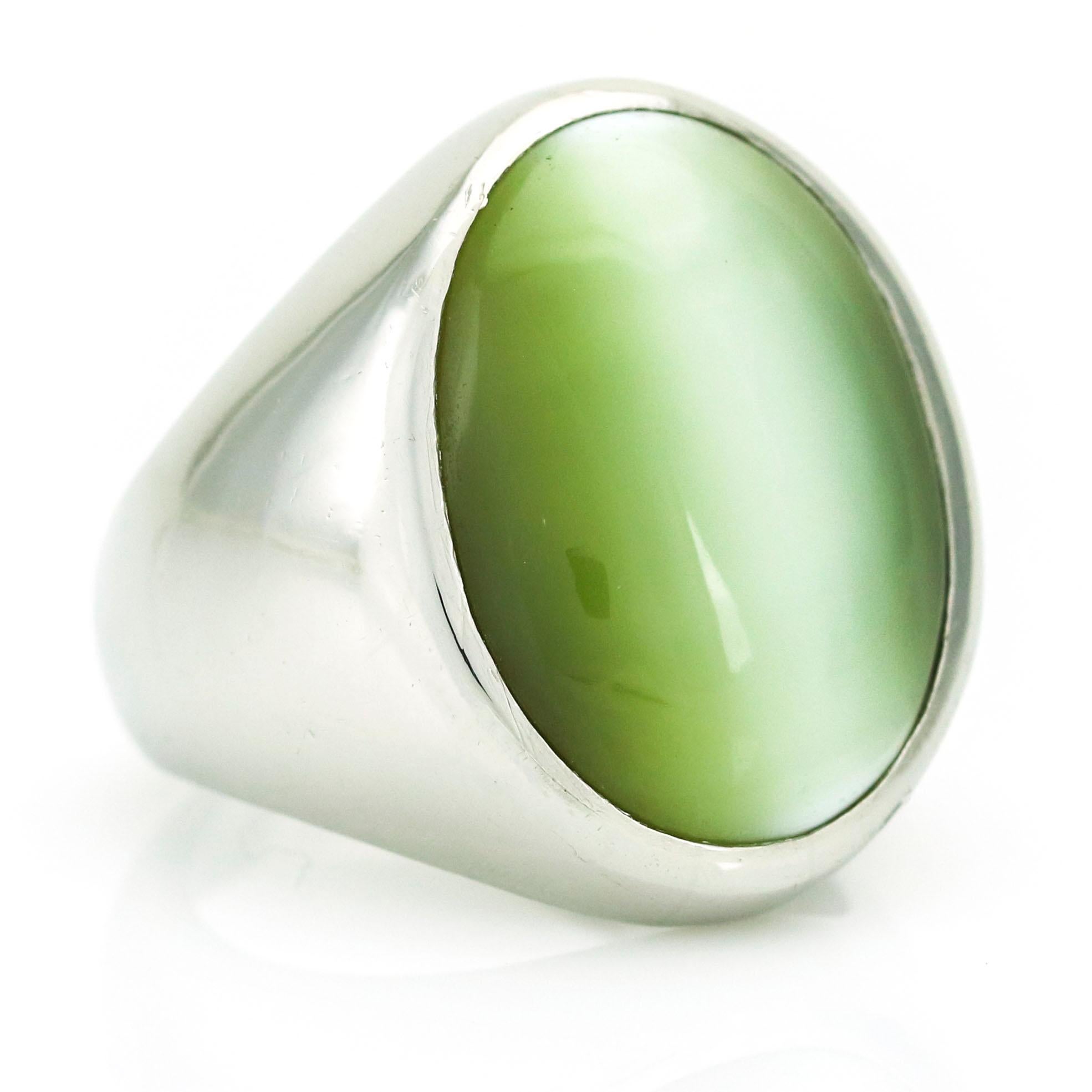 Gemstone signet ring in platinum with GIA Origin Report. The ring is bezel set with an oval double cabochon yellow-green natural cat's eye Chrysoberyl stone. Polished metal finish. Unisex.

Size, 7.5
Estimated Gemstone Total Carat Weight, 25.00
