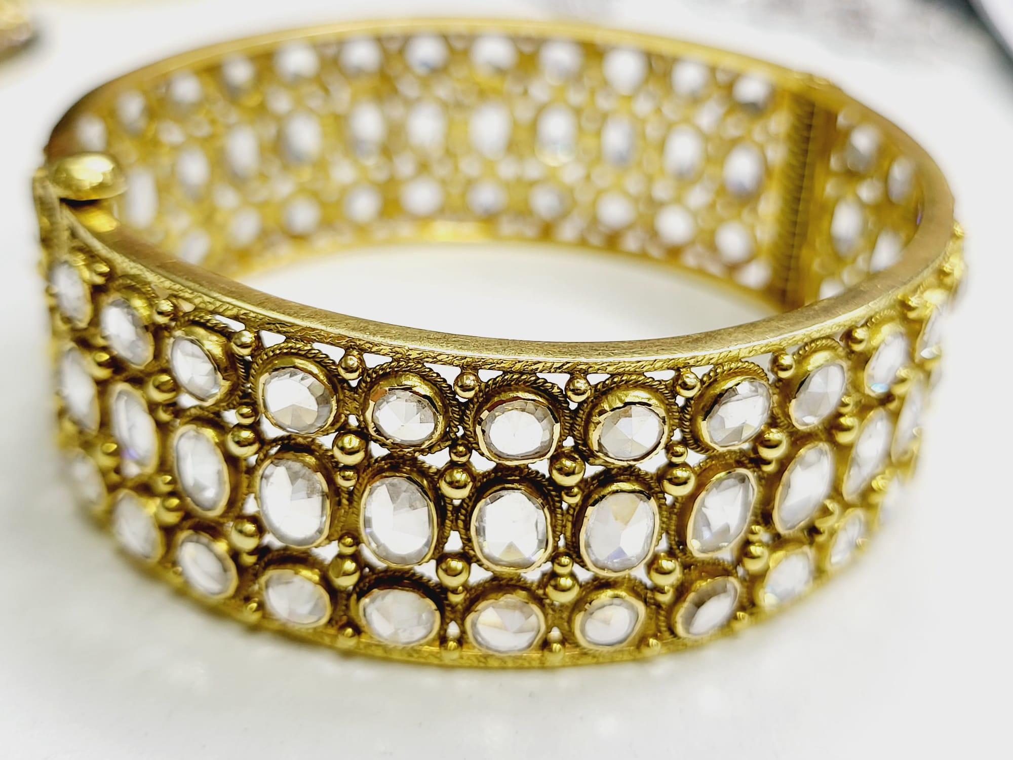 Title:
25.00 Carat Rose Cut J SI1 Diamond 18 Karat Yellow Gold Bangle Bracelet


Style:
Bangle


Metal:
18 Karat Yellow Gold


Gemstone 1:
12 Carat Diamond


Number of Stones:
64


Color:
J


Clarity:
SI1


Shape:
Rose Cut


Gemstone 2:
13 Carat
