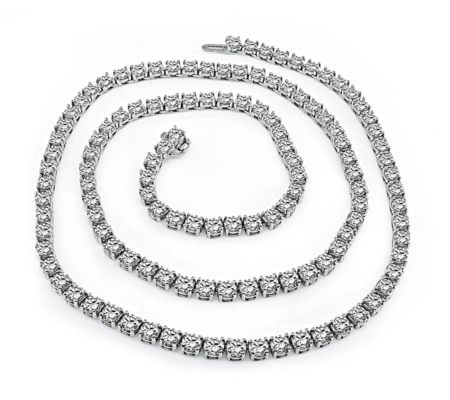 This is a stunning 14k white gold necklace. The necklace is set with sparkling round cut diamonds that weigh approximately 25.00ct. The color of these diamonds is I-J with VS clarity. The necklace measures 21 1/2 inches in length and 4mm in width.