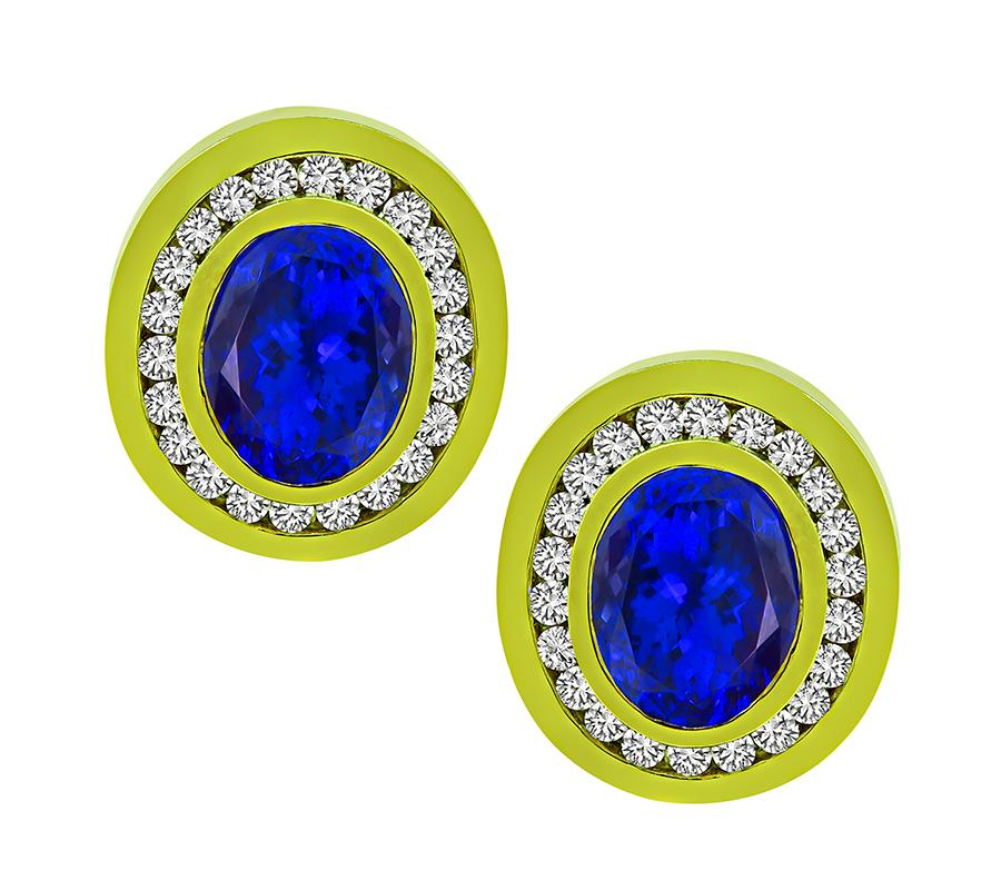 This is a charming pair of 18k yellow gold earrings. The earrings feature lovely oval cut tanzanites that weigh approximately 25.00ct. The tanzanites are accentuated by sparkling round cut diamonds that weigh approximately 5.00ct. The color of these