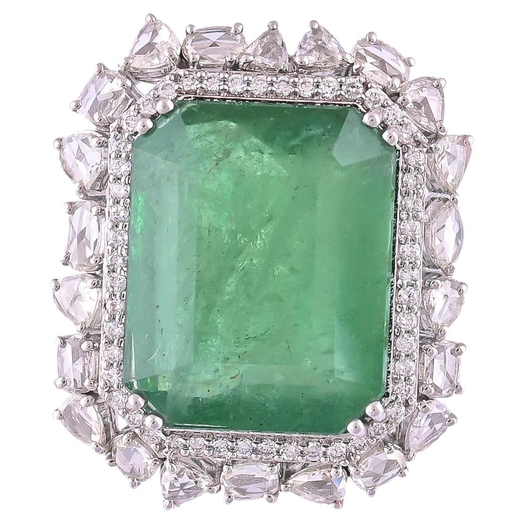 A very gorgeous and one of a kind, Emerald Cocktail Ring set in 18K Gold & Diamonds. The weight of the Emerald is 25.01 carats. The Emerald is completely natural, without any treatment and is of Zambian origin. The weight of the Rose Cut Diamonds is