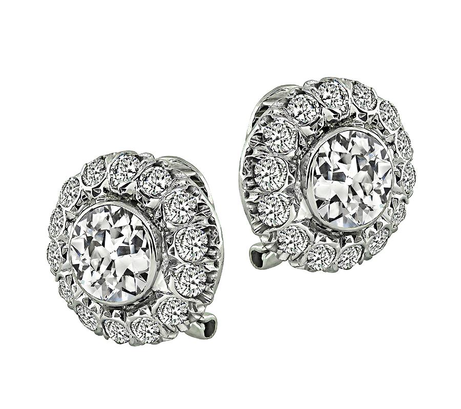 This is a gorgeous pair of 18k white gold earrings. The earrings feature sparkling old mine cut diamonds that weigh approximately 2.50ct. The color of these diamonds is J-K with VS1 clarity. The center diamonds are accentuated by dazzling round cut