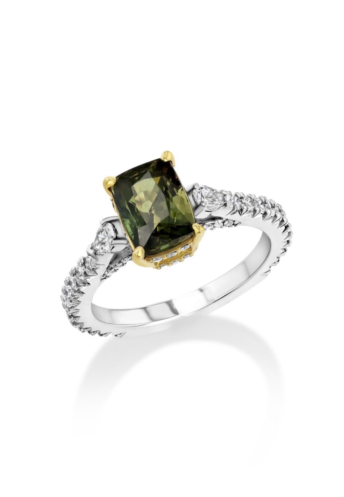 2.50ct cushion-cut Alexandrite from Sri Lanka is nestled in 18K yellow gold with platinum. The spellbinding Alexandrite is flanked by two pear-cut and numerous round diamonds totaling 0.62 carats. 

This Alexandrite changes from yellow-green to