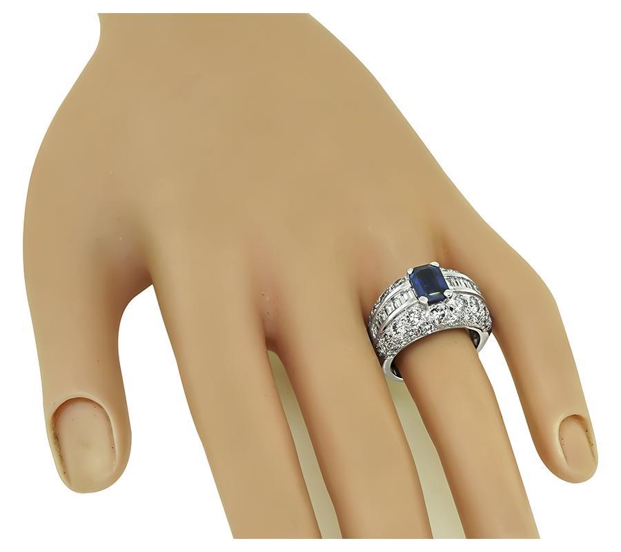 This is a gorgeous 14k white gold ring. The ring is centered with lovely emerald cut Ceylon sapphire that weighs approximately 1.64ct. The sapphire is accentuated by sparkling baguette and round cut diamonds that weigh approximately 2.50ct. The