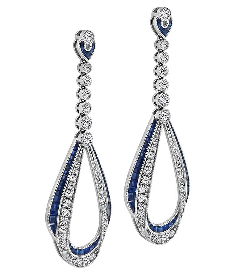 This is a fabulous pair of 14k white gold dangling earrings. The earrings feature sparkling round cut diamonds that weigh approximately 2.50ct. The color of these diamonds is H with VS clarity. The diamonds are accentuated by lovely square cut