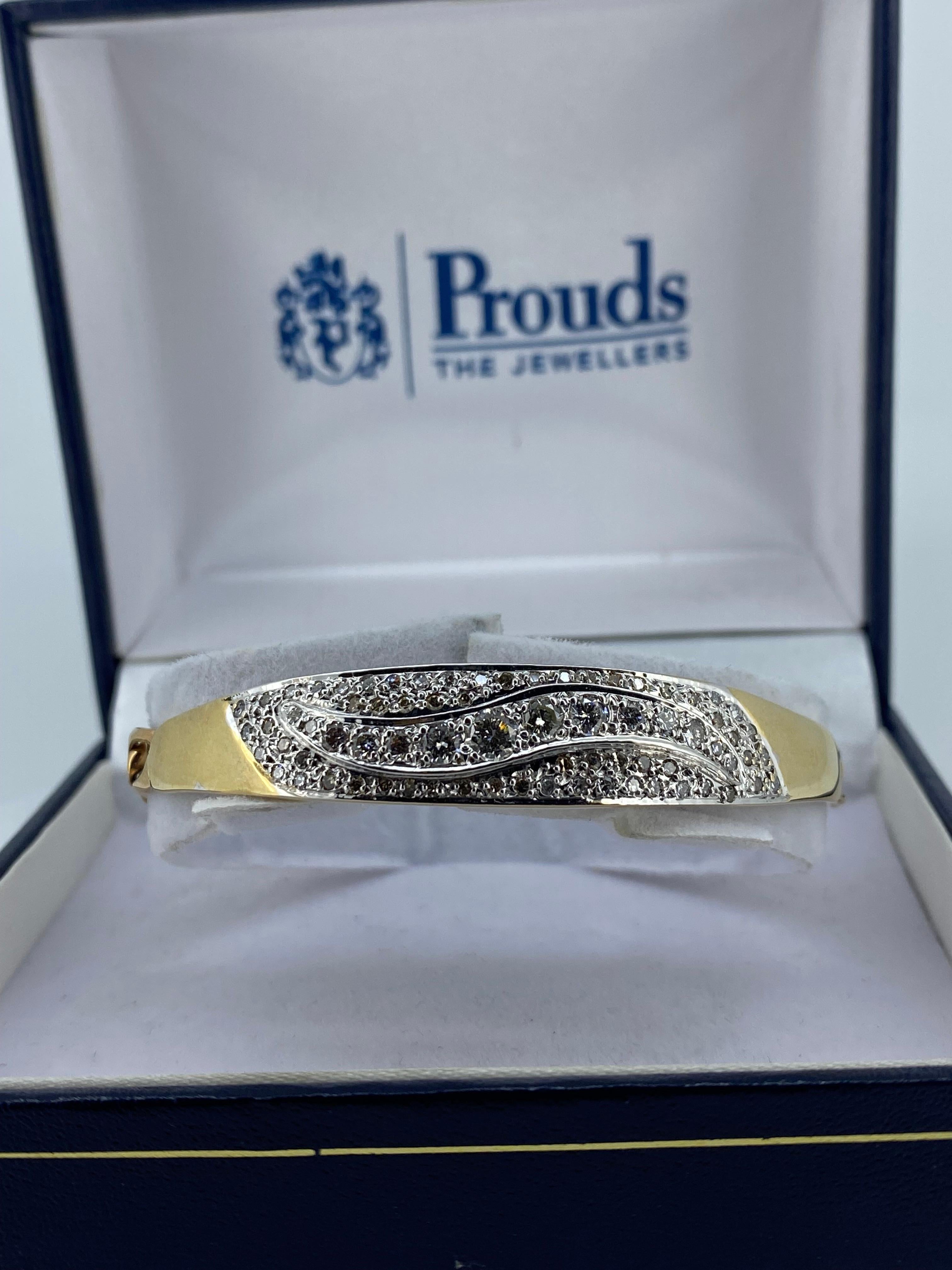 Half bangle / half bracelet, 
this magnificent piece was made 
by renowned Italian jewellers 
UNOAERRE (established in 1926)
in 1980's 

It's lavishly pave set with sparkling
Round Brilliant Cut Diamonds 
of 2.50ct approx. 
in 5 rows 
with centre