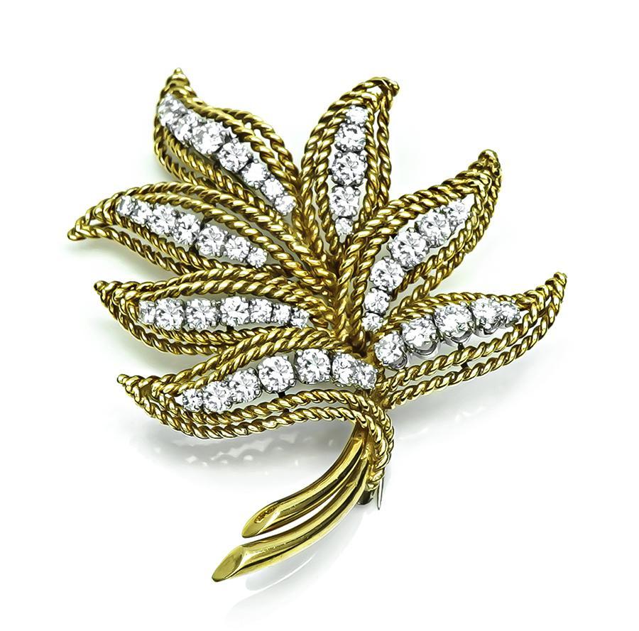 This is a stunning 18k yellow and white gold pin. The pin is set with sparkling round cut diamonds that weigh approximately 2.50ct. The color of these diamonds is F-G with VS clarity. The pin measures 52mm by 41mm and weighs 17.7 grams. The pin is