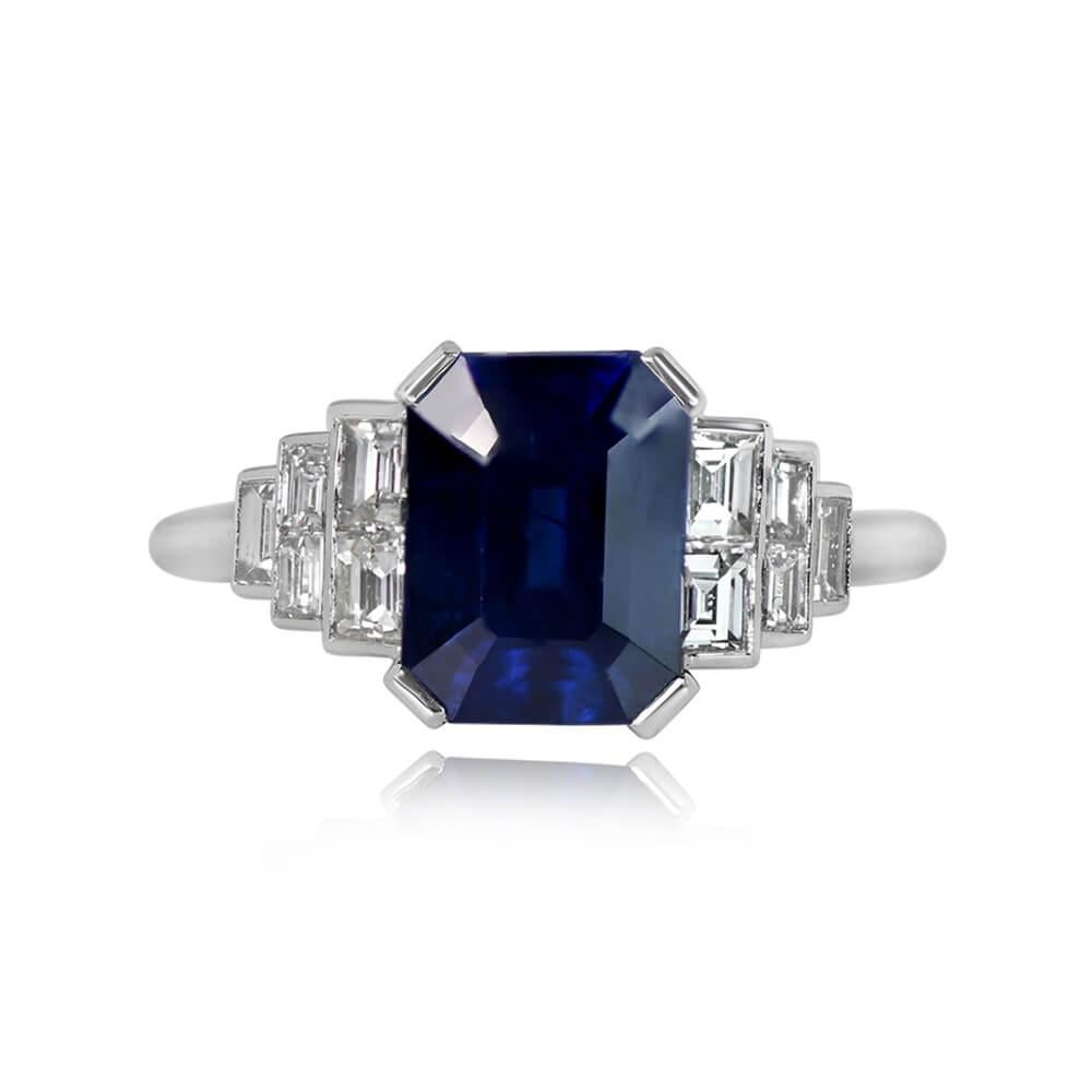 An exquisite sapphire engagement ring highlighting a 2.50-carat emerald cut natural sapphire in a secure prong setting. Geometric elegance is enhanced by graduating baguette-cut diamonds on each side of the center gem, totaling around 0.52 carats.