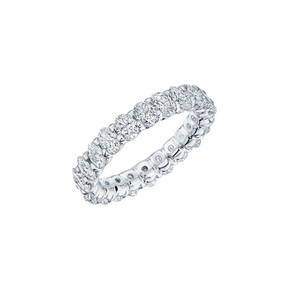 • Crafted in 18KT gold, this band is made with 25 oval cut diamonds which encircle the finger , and has a combining total weight of approximately 2.50 carats. The diamonds are set into a shared prong cup style setting. Worn beautifully on its own or