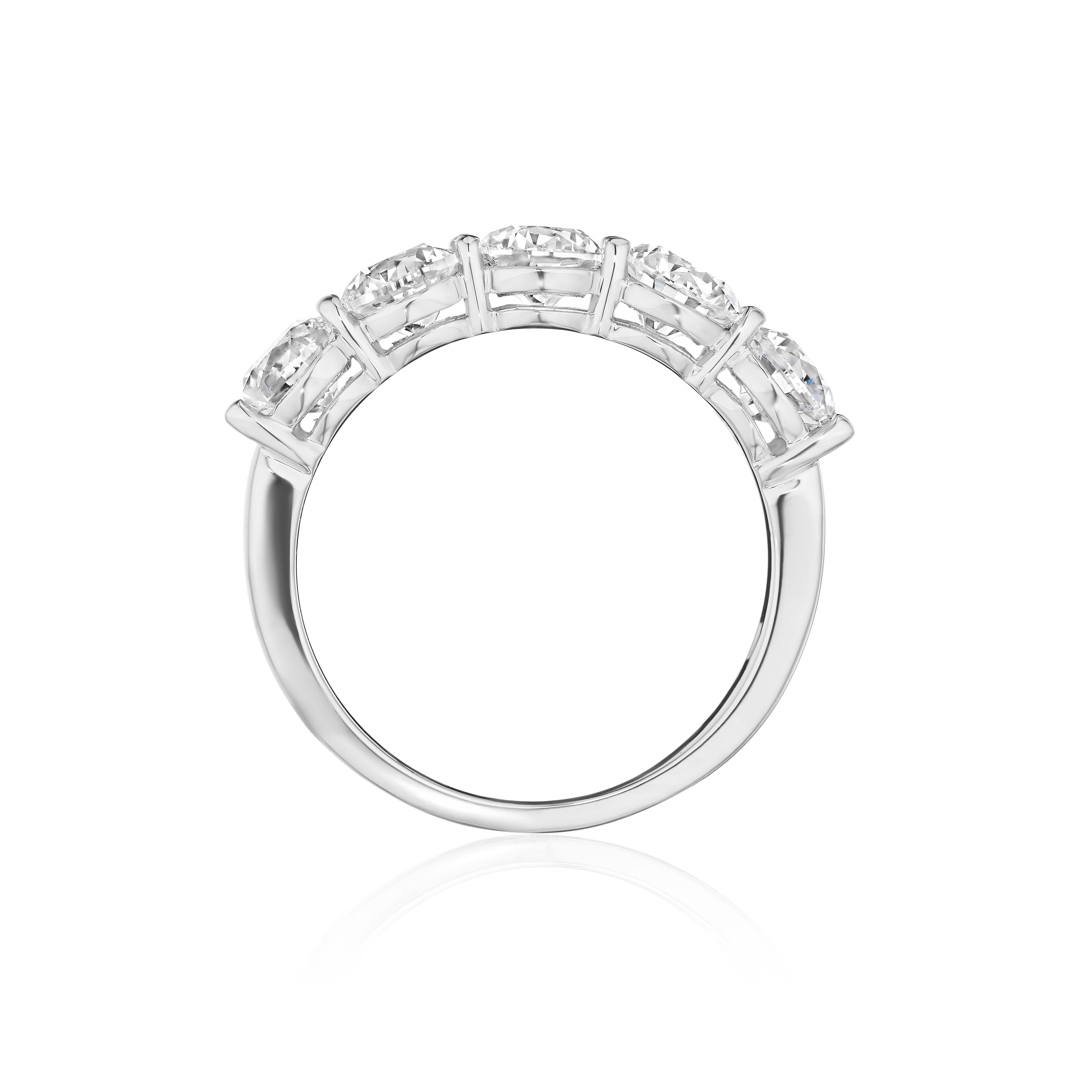 • Crafted in 18KT gold, this band is made with 5 round brilliant cut diamonds, and has a combining total weight of approximately 2.50 carats. The diamonds are set into a shared prong setting. Worn beautifully on its own or stacked. A beautiful and