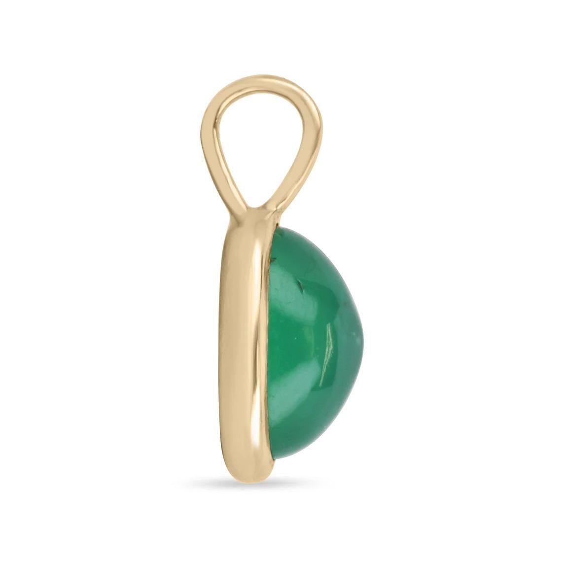 Featured here is a stunning, cabochon natural oval emerald pendant in fine 14K gold. Displayed is a medium-green emerald bezel-set. The earth mined, green cabochon emerald has a charming green color with good clarity. This is an excellent gift for a